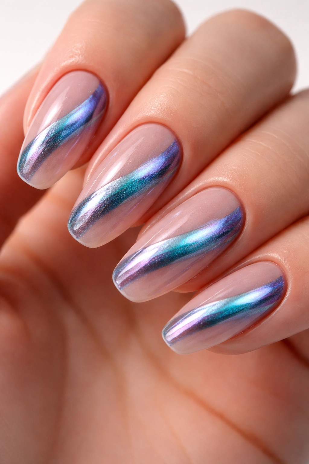 Nails with nude base and teal-purple cat-eye chrome stripe shimmering