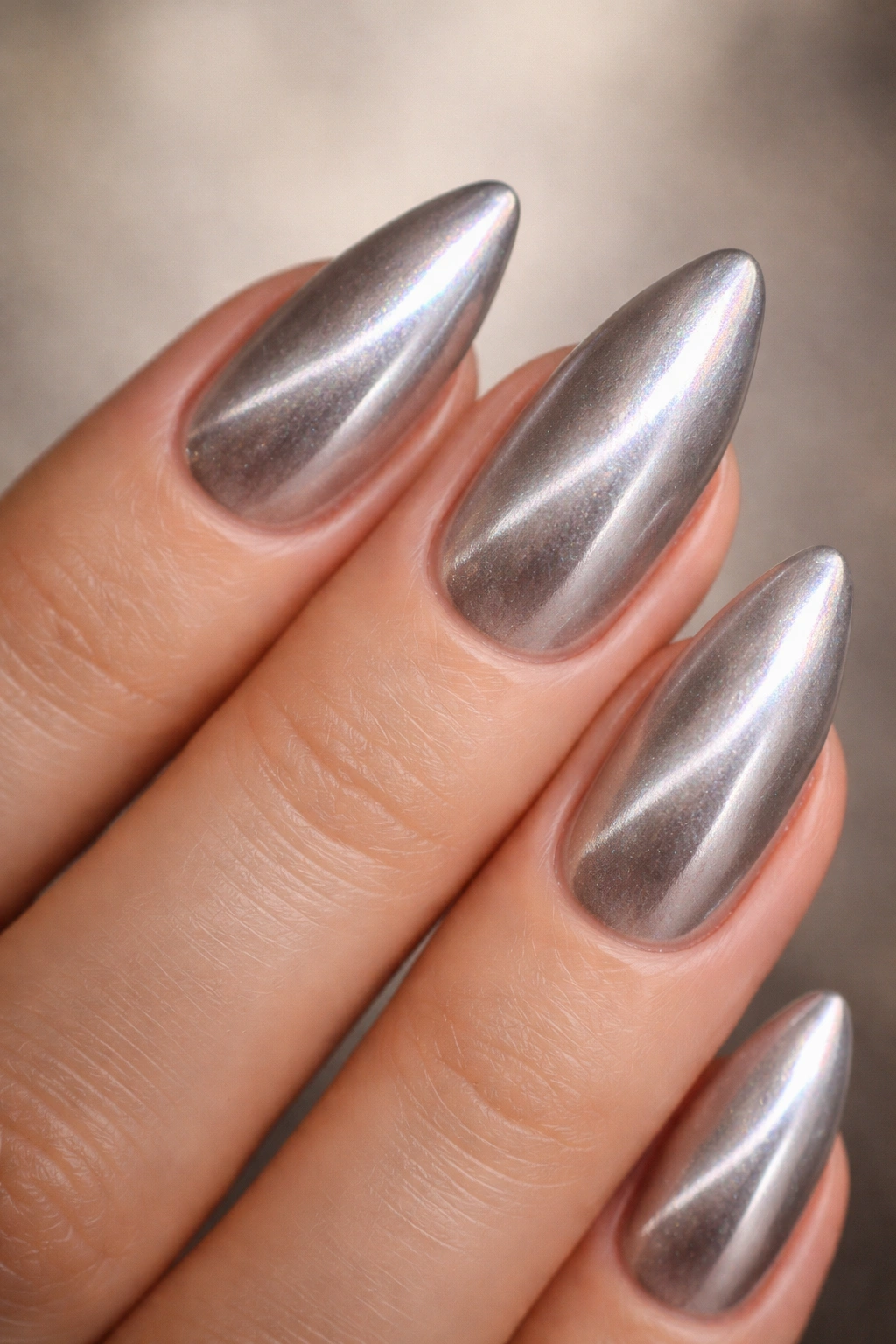 Close-up of cat-eye chrome almond nails with diagonal stripe