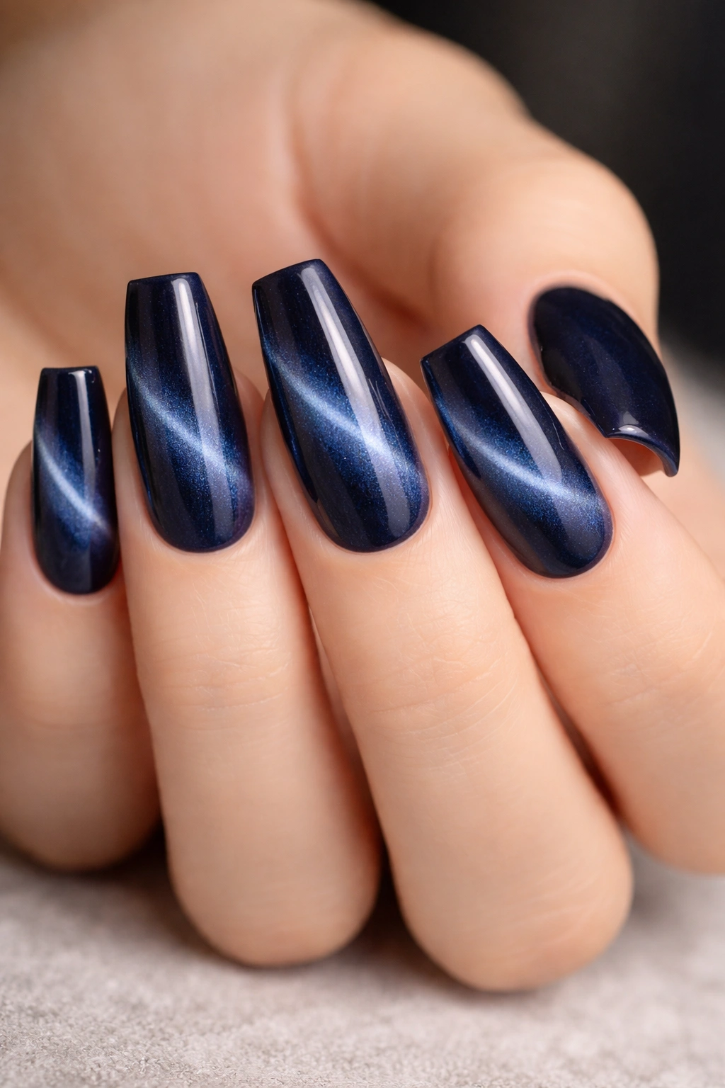 Medium length nails with midnight blue cat eye stripe on ballerina shape