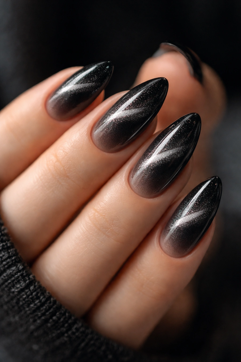 Almond nails with velvet black cat-eye shimmer on ombre base