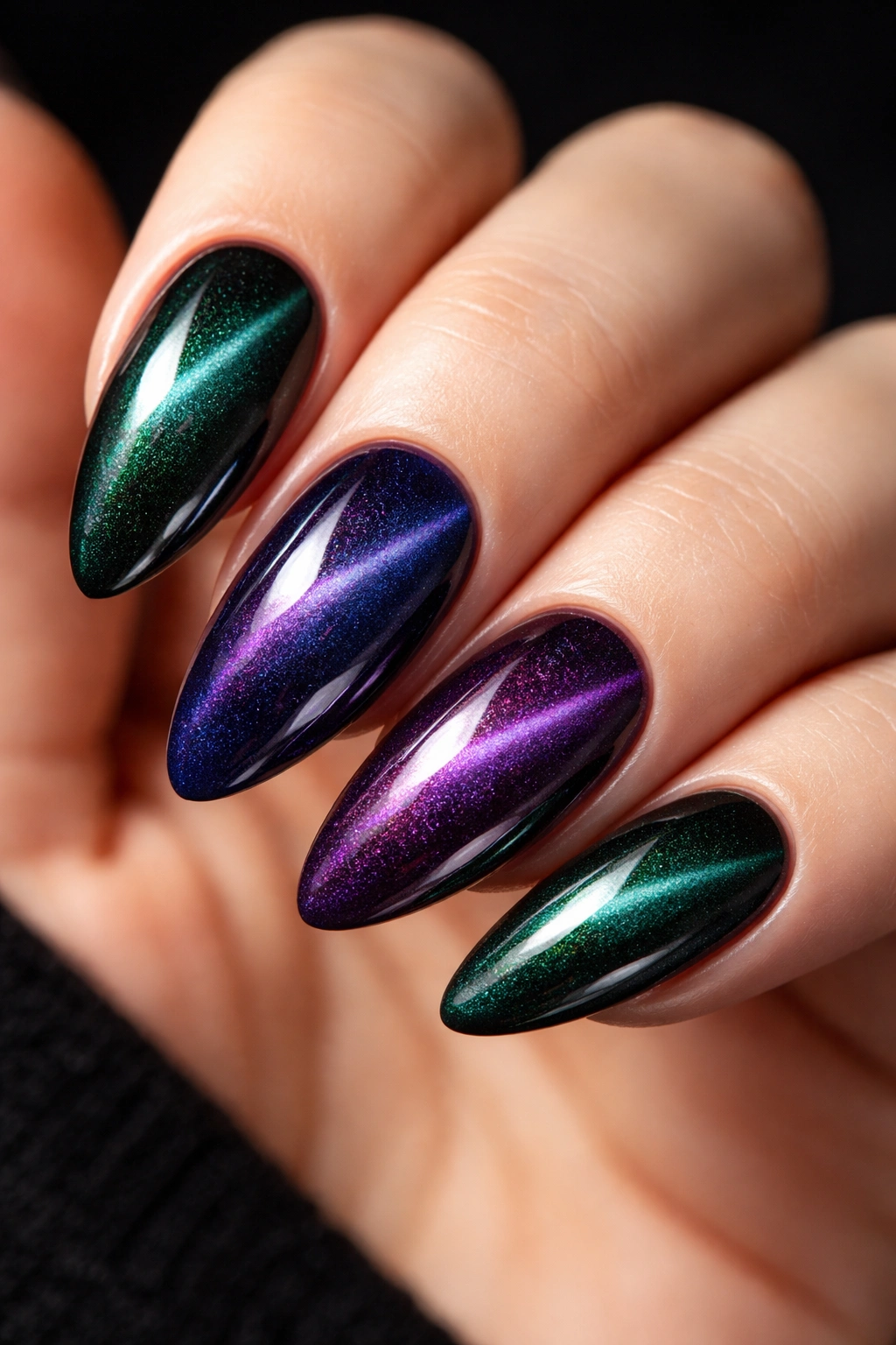 Almond nails with moody cat eye velvet magnetic shift in deep jewel tones