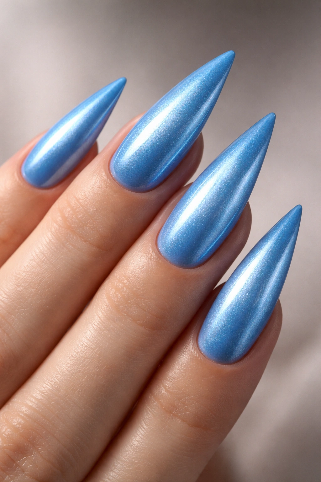 Cerulean blue nails with pearl shimmer finish on stiletto tips