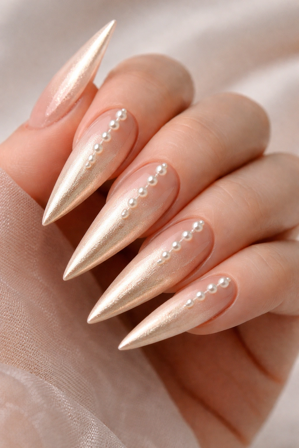 Close-up of champagne ombre stilettos with pearl accents