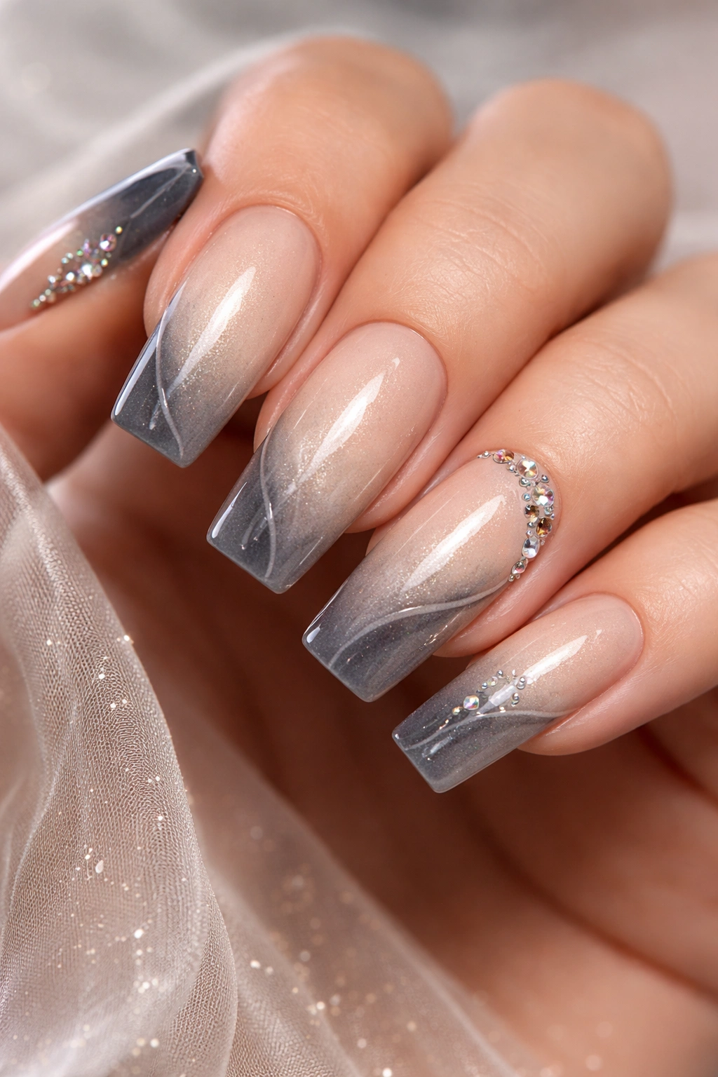 Nails with champagne to gray ombre and rhinestone accents