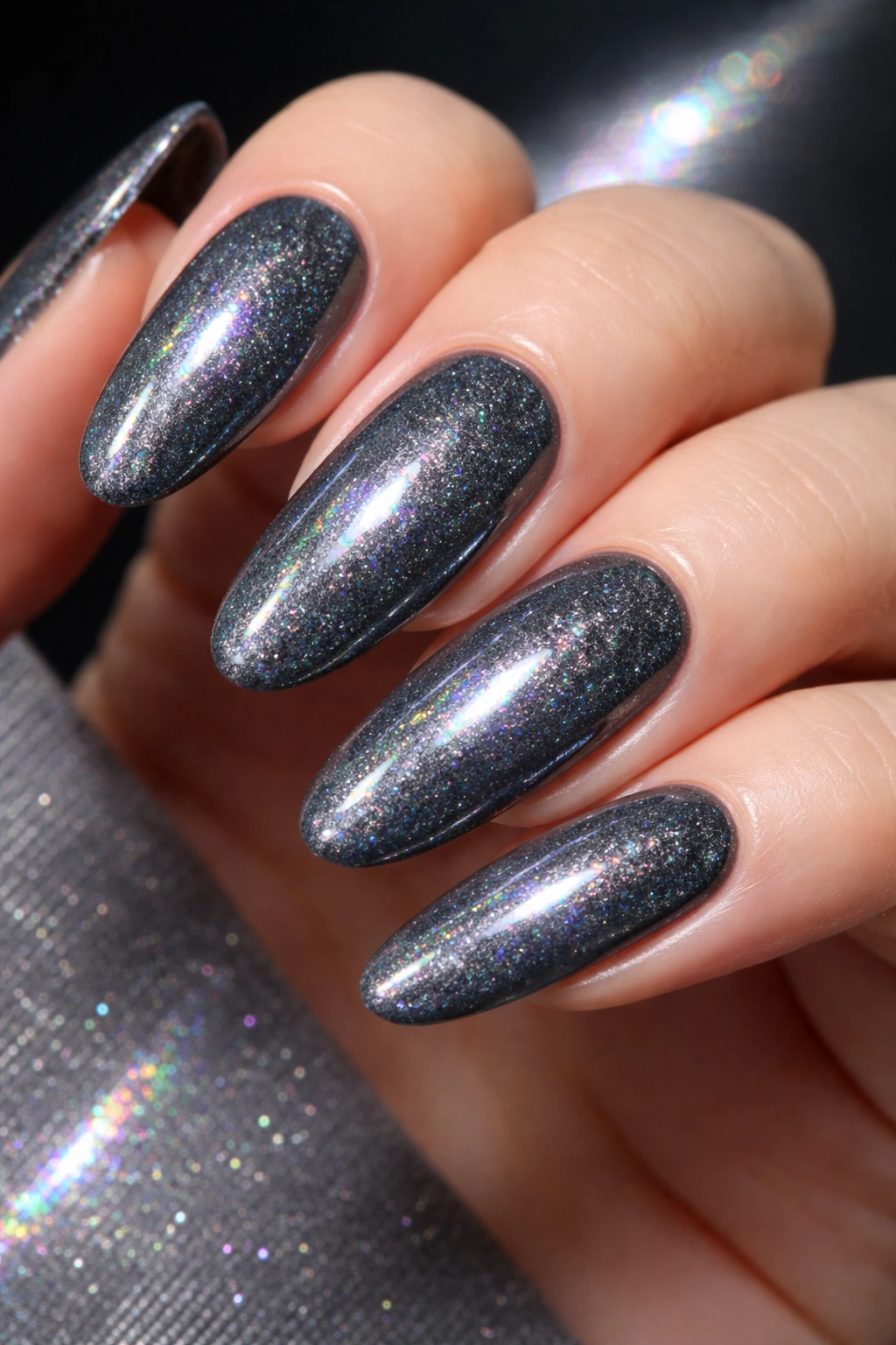 Charcoal gray nails with holographic shimmer on long ovals