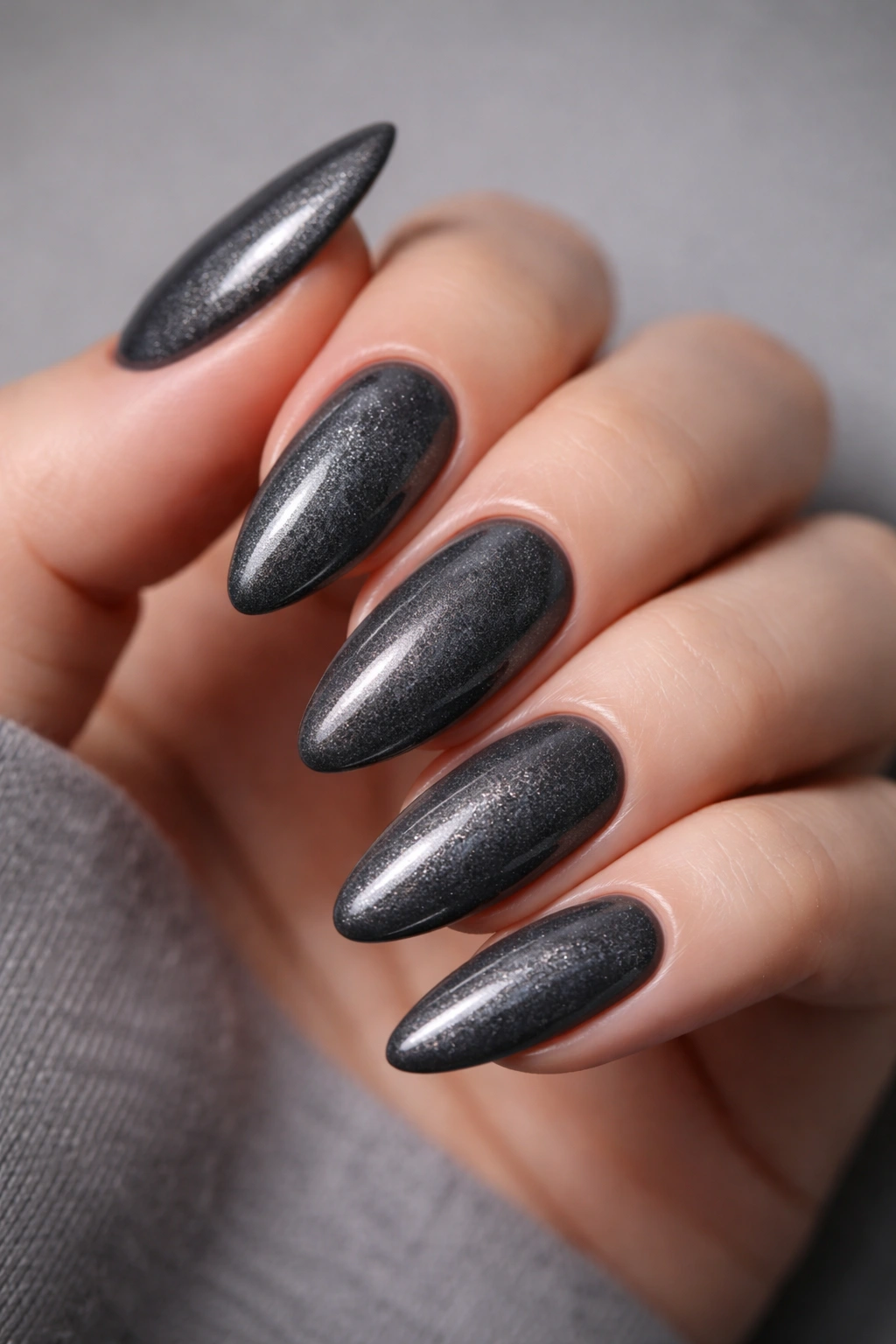 Charcoal gray almond nails with micro-shimmer gradient