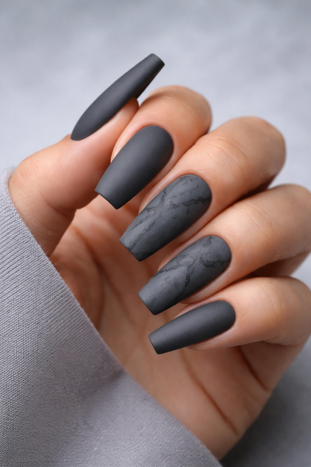 Charcoal matte nails with subtle tone-on-tone veining.