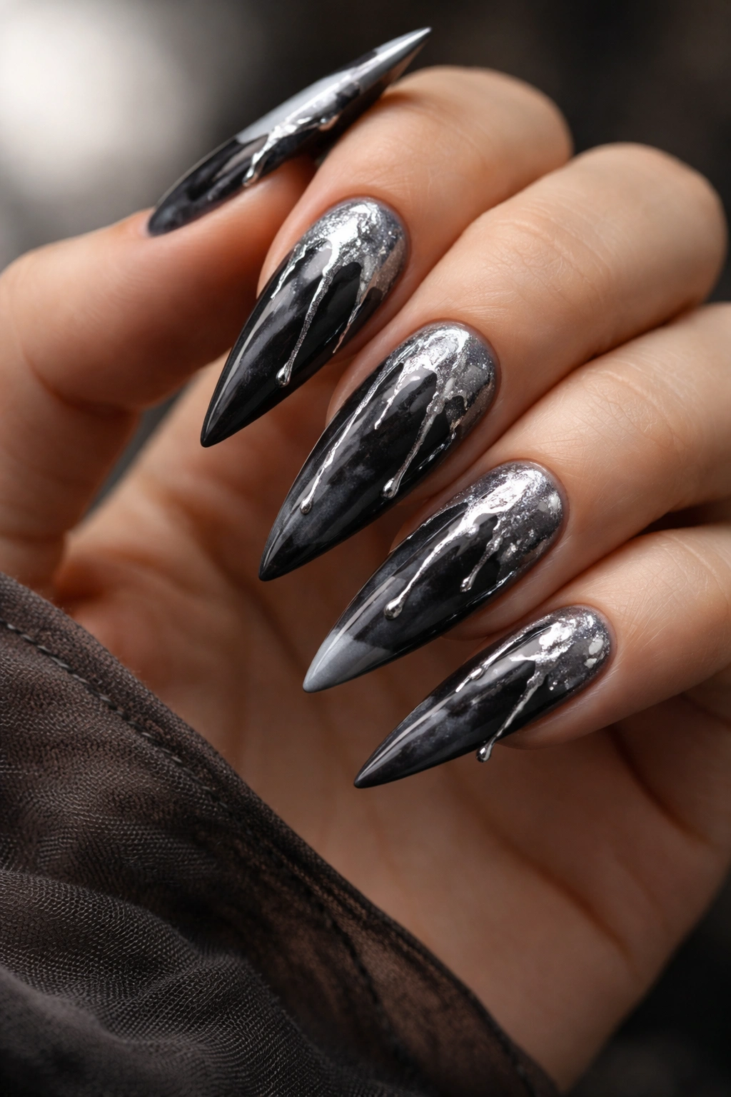 Charcoal grey nails with silver drip pattern