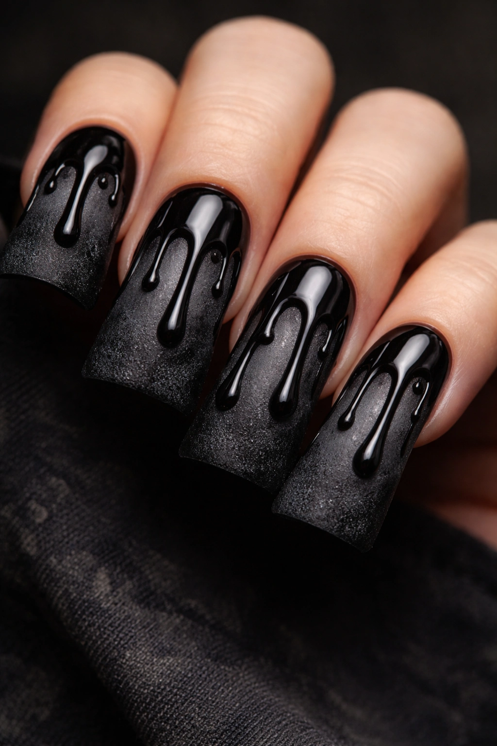 Close-up of charcoal nail with thick tar drip on an elongated duck nail