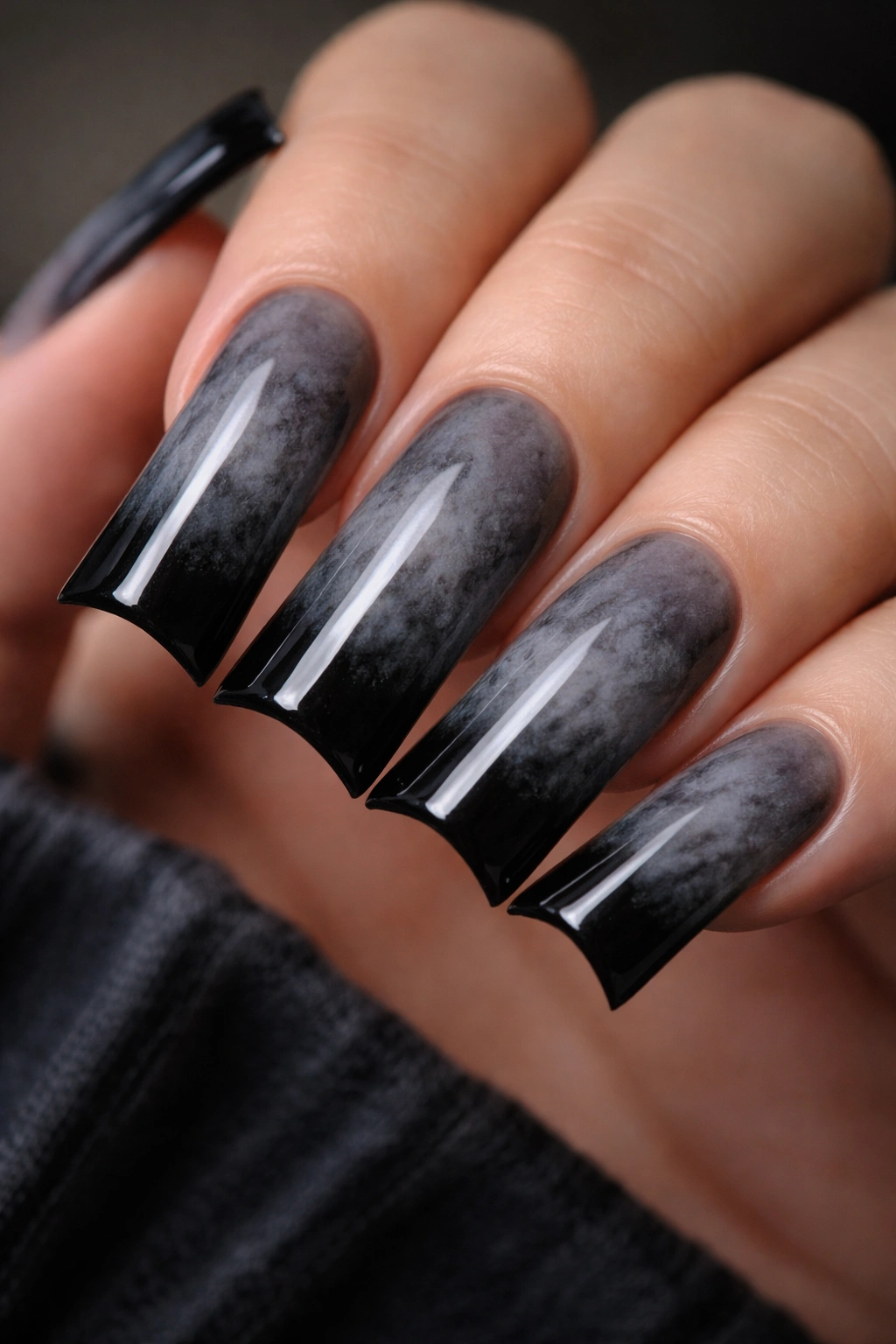 Close-up of duck nails with charcoal gray base and black-tipped smoky gradient.