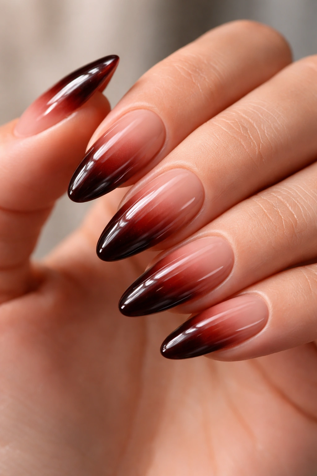 Almond nails with cherry cola brown-red ombre and glossy finish