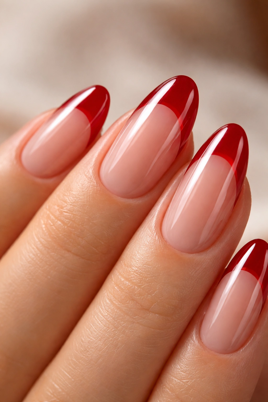 Close-up of short almond nail with cherry red jelly French tip