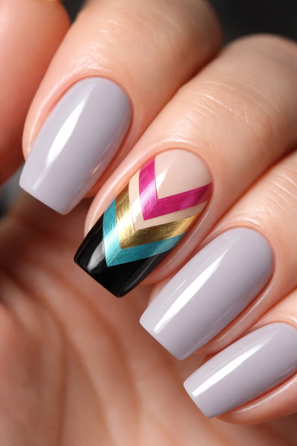 Nails with bold chevron pattern created with striping tape