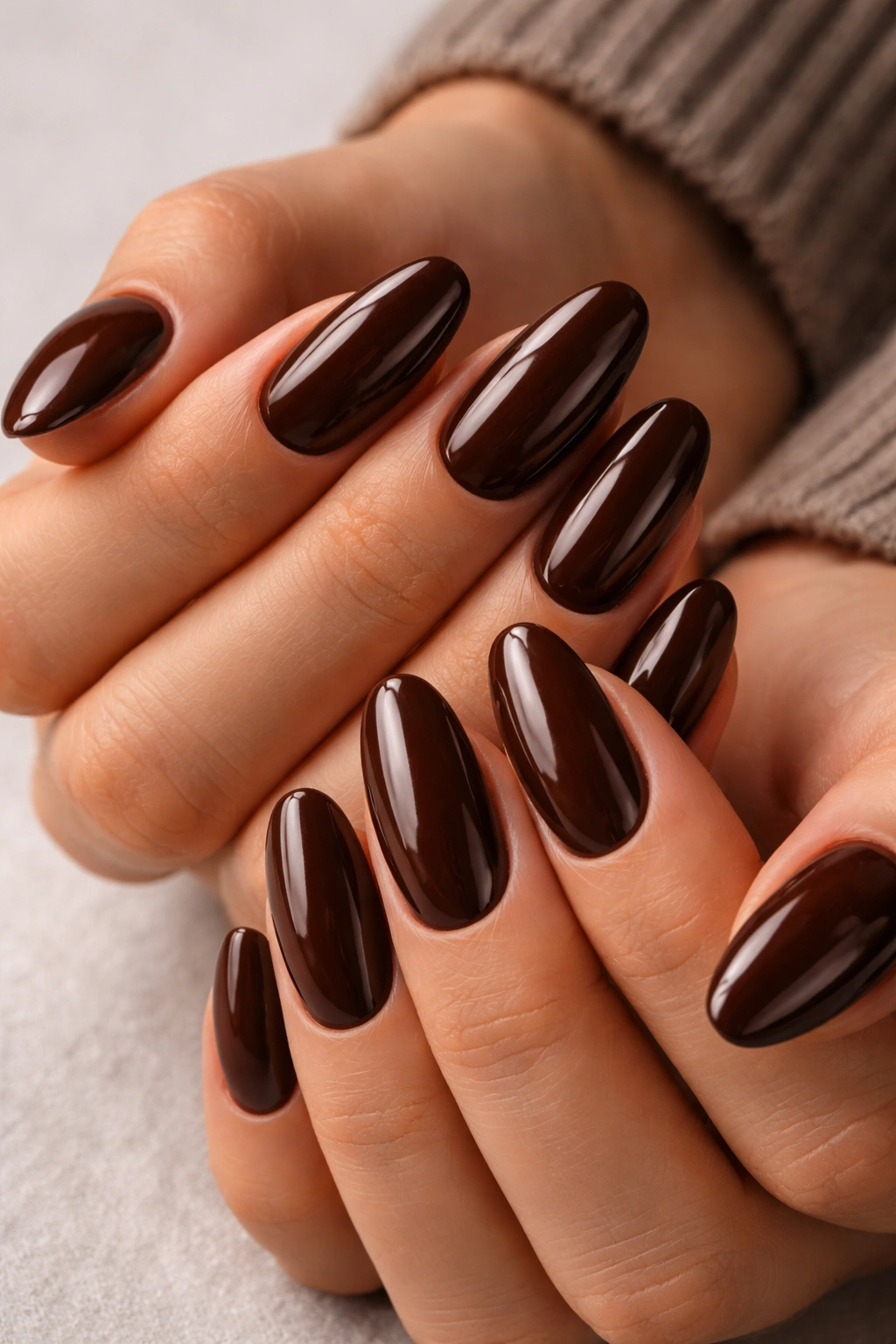 Close-up of chocolate brown dip powder nails with rich color
