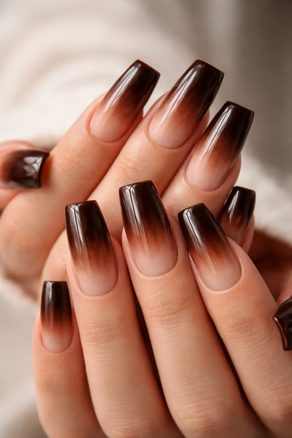 Close-up of chocolate brown ombré duck nails with glossy finish