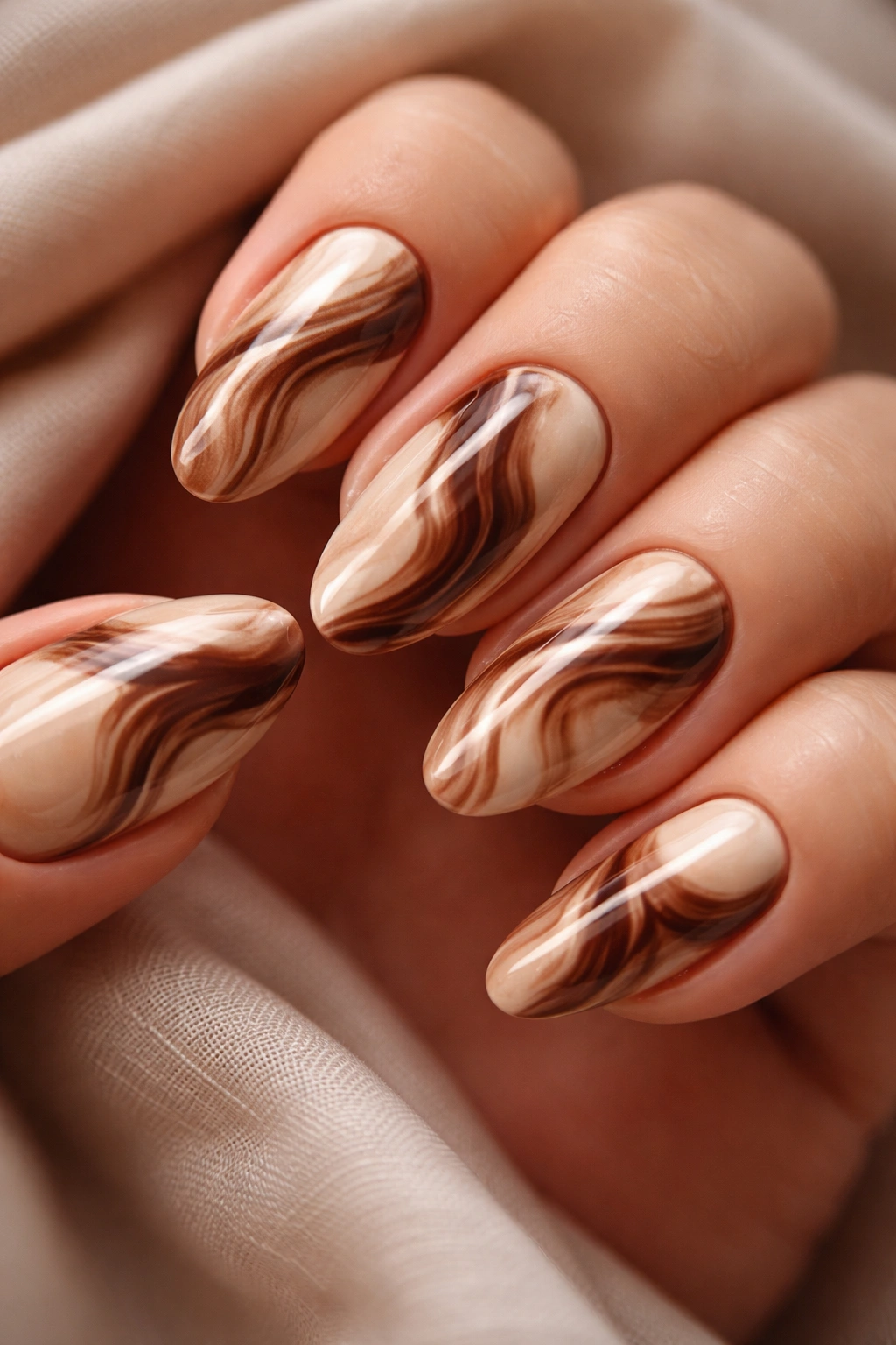 Nails with cream and mocha marble swirl patterns