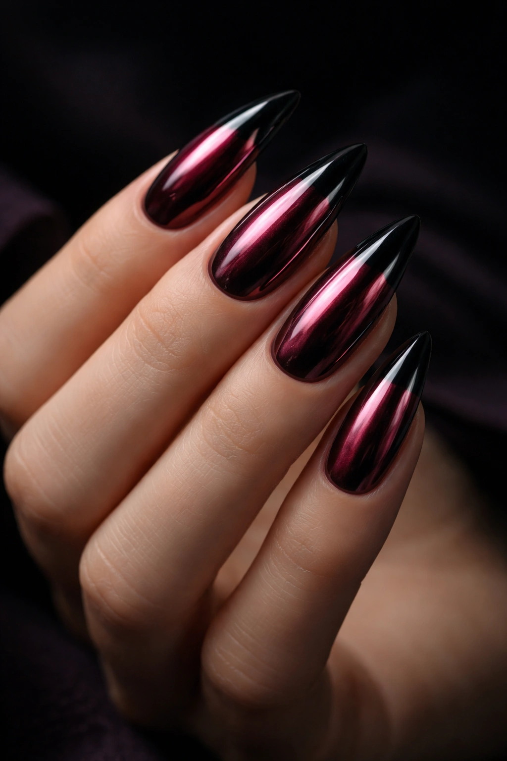 Burgundy chrome nails with black tips catching light