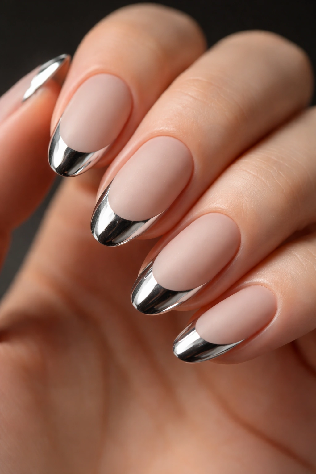 Oval nails with metallic chrome French tips on a matte base.