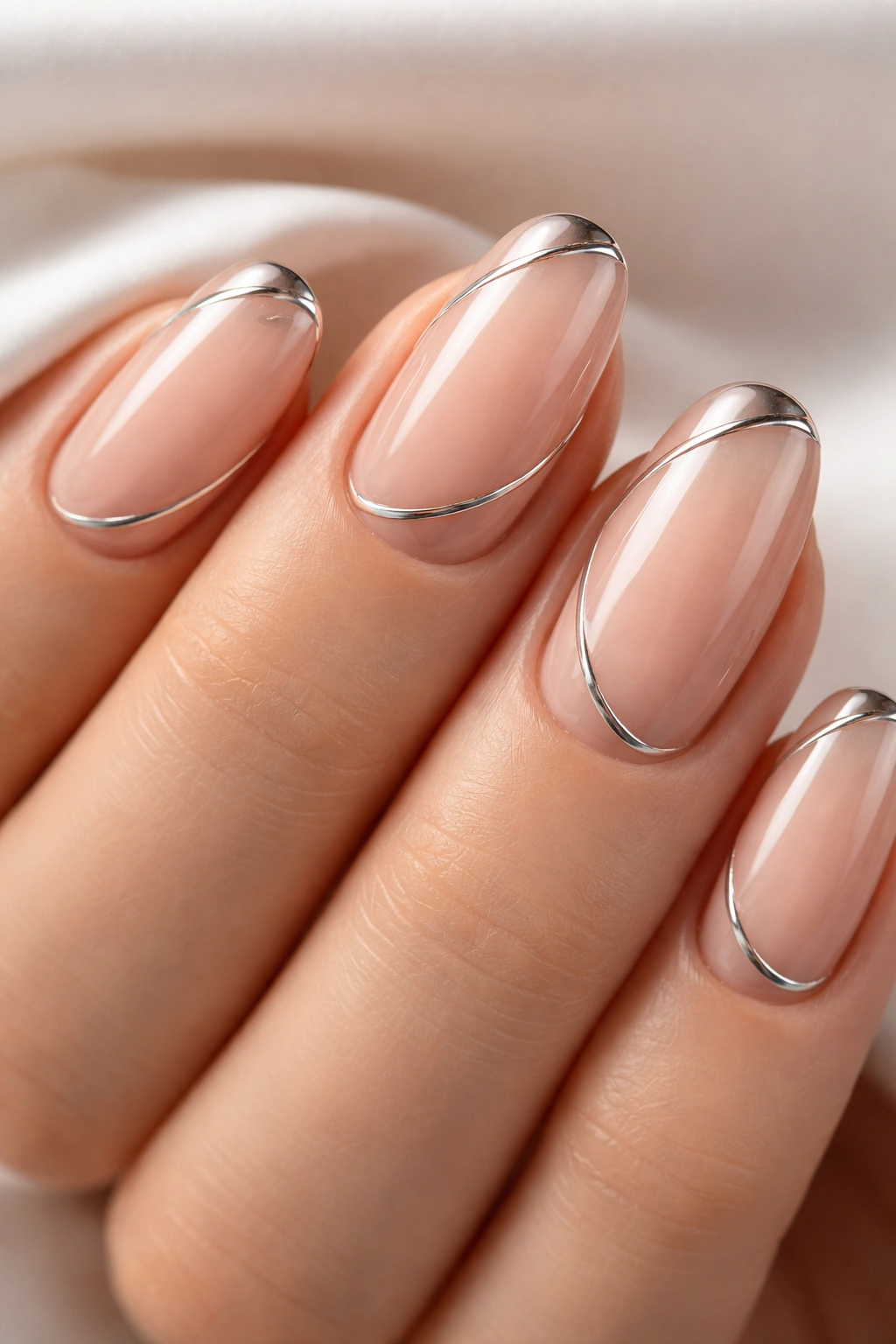 Nude nails with thin chrome lines creating a minimalist metallic look