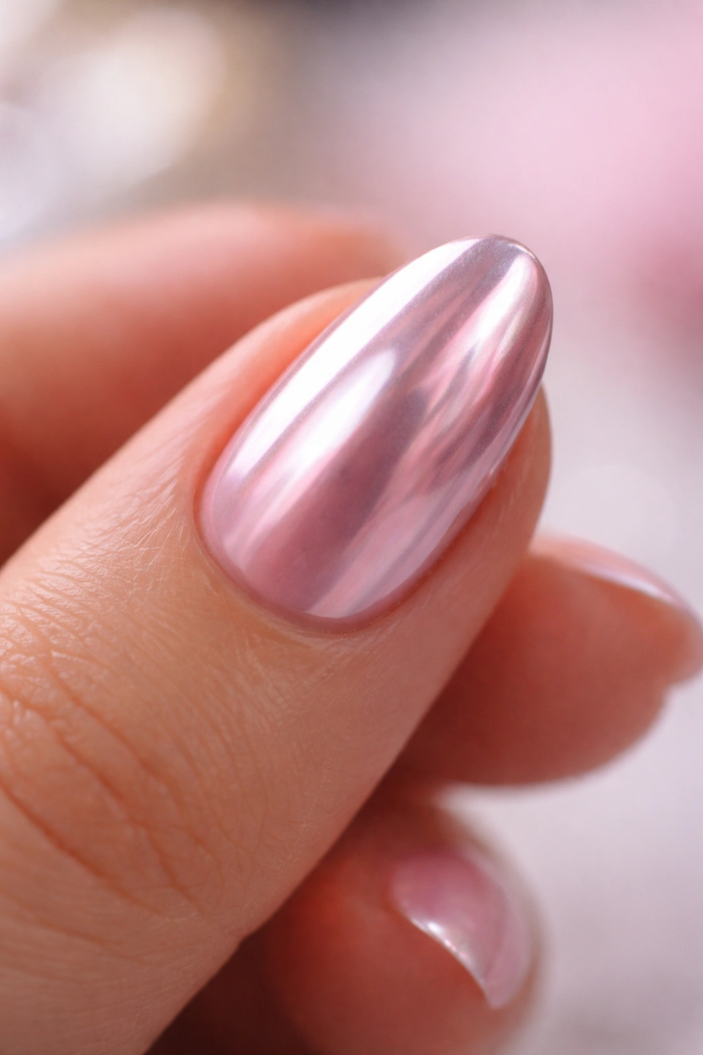 Close-up of a short almond nail with durable chrome finish and smooth surface