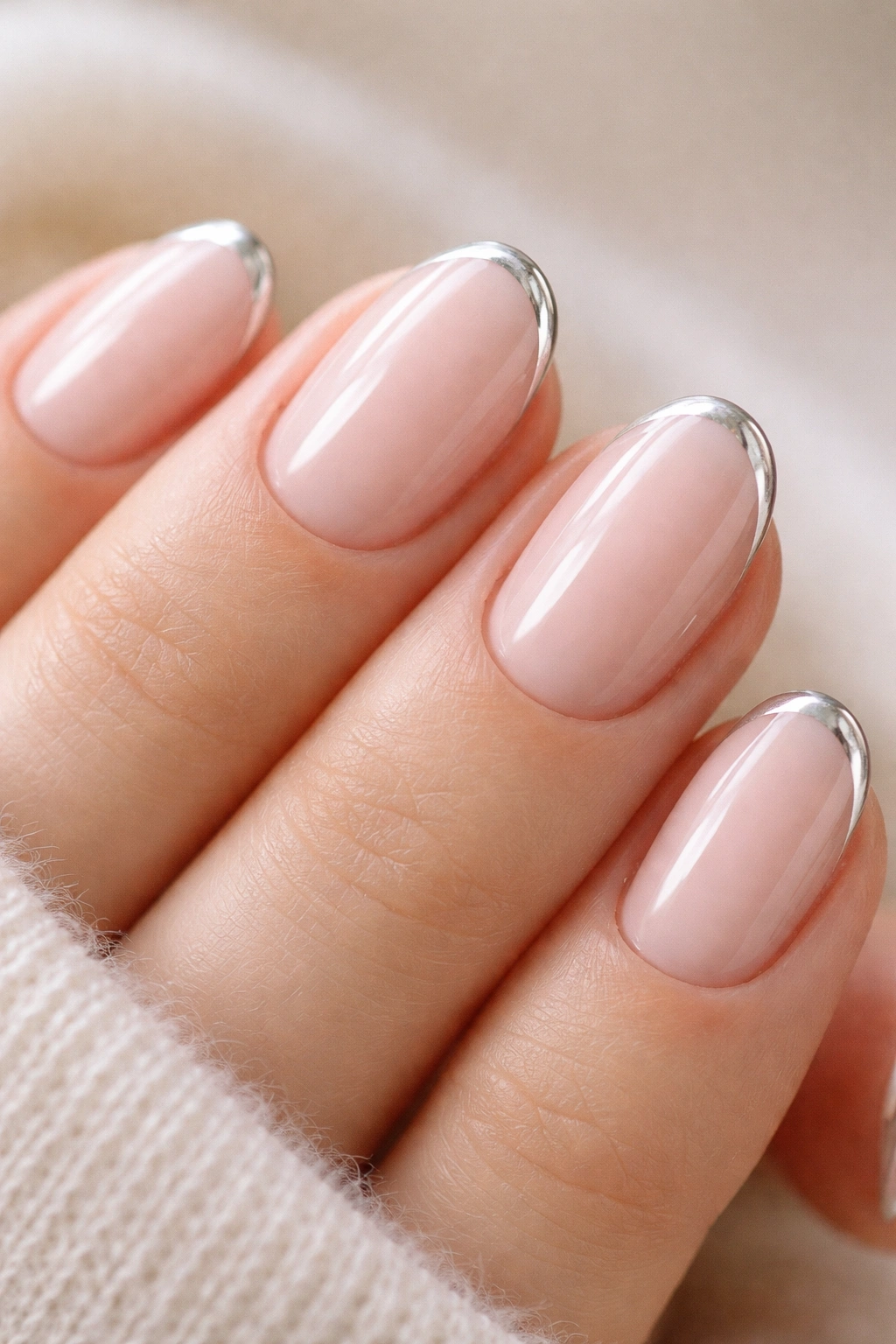 Short oval nails with chrome micro French tips on pale pink base