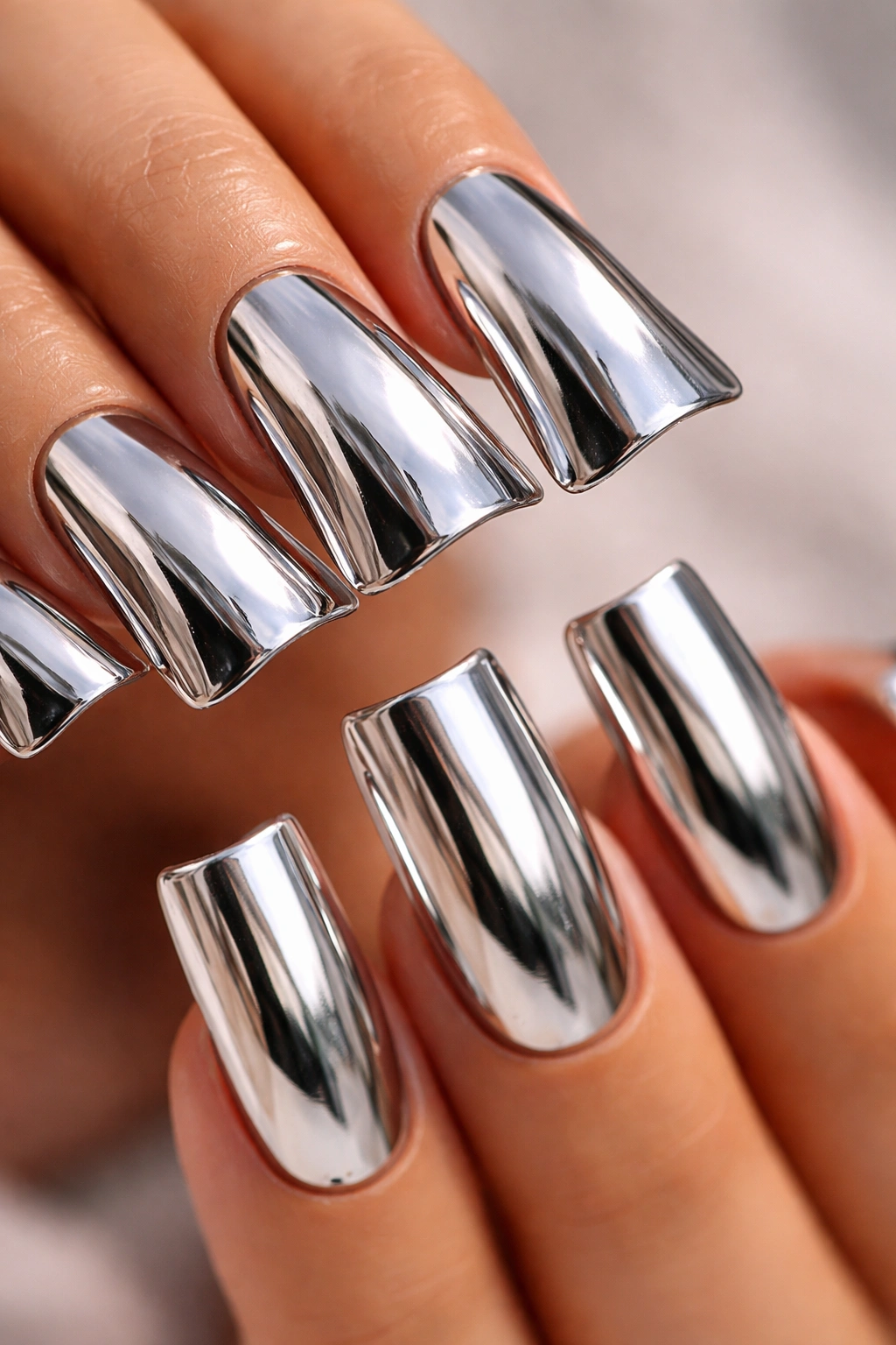Close-up of duck nails with chrome mirror finish reflecting light