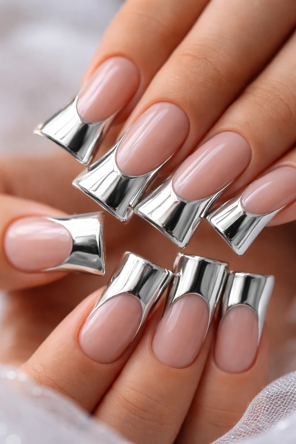 Duck nails with chrome silver tips reflecting light.