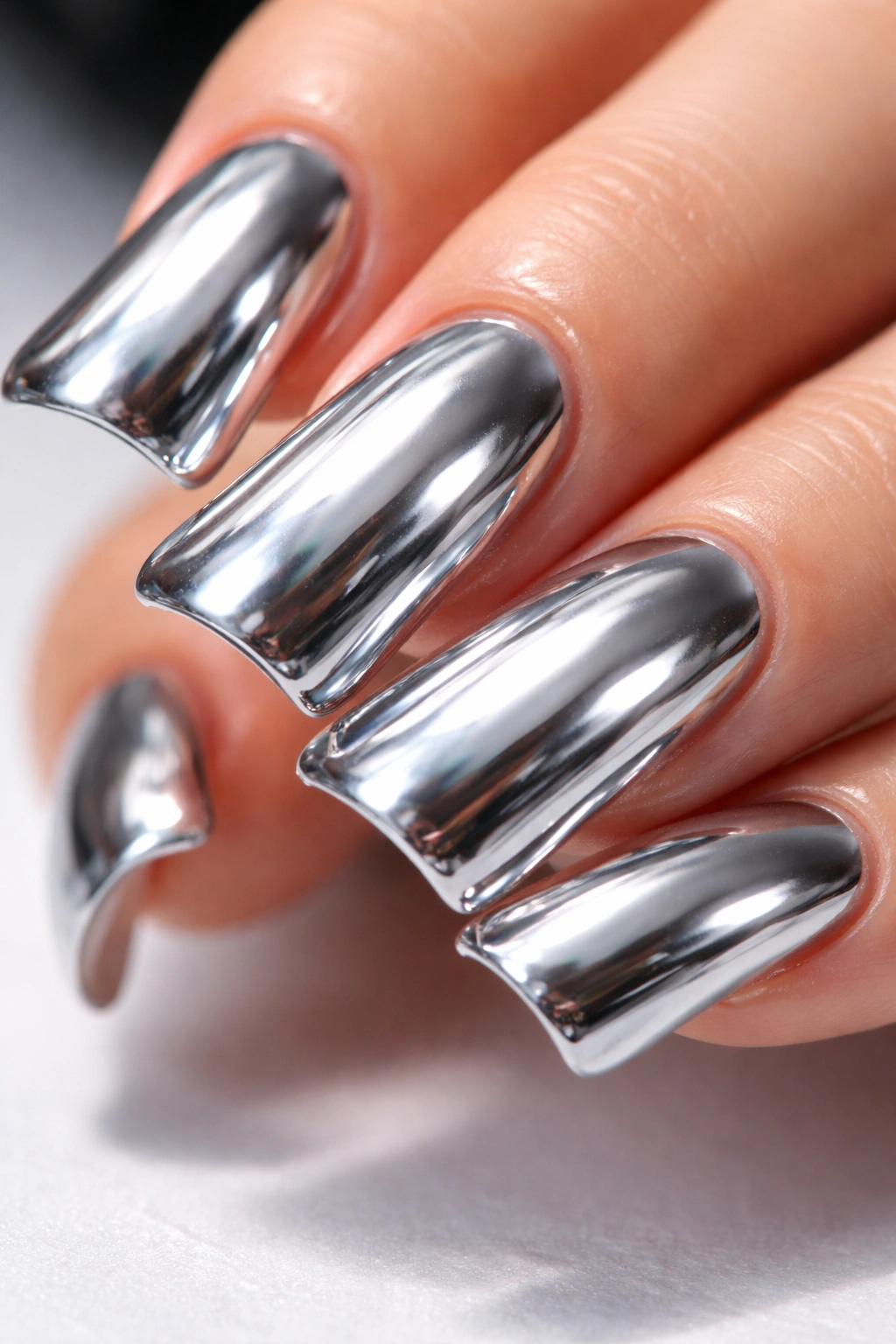 Duck nails with chrome mirror finish reflecting surroundings
