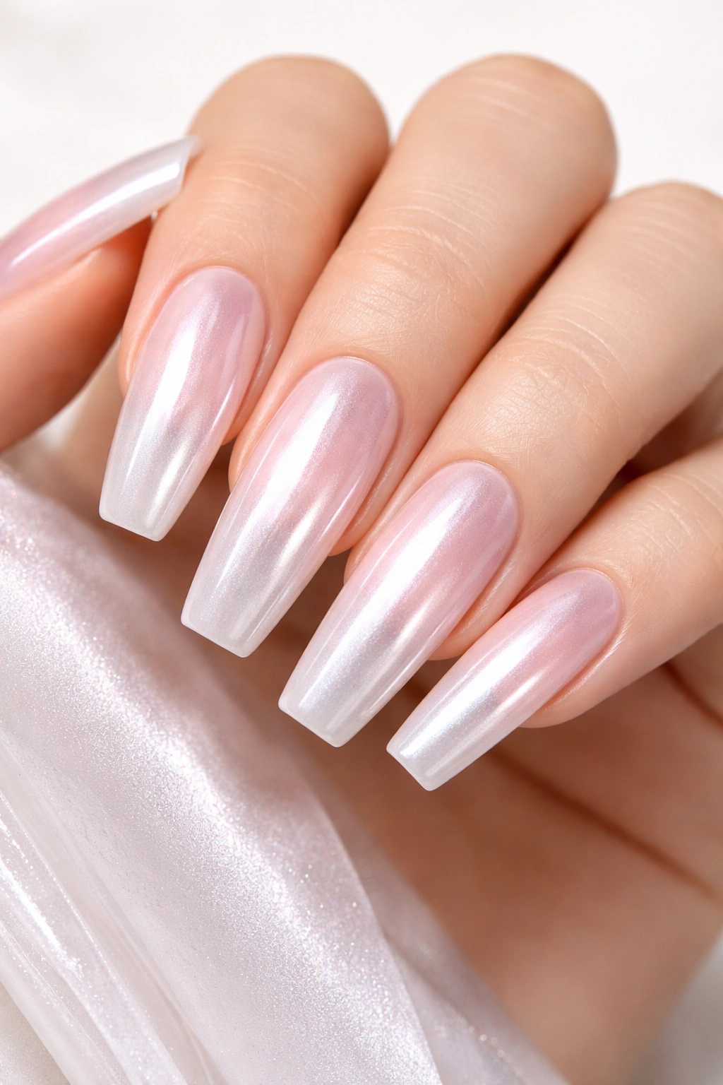 Close-up of nails with pearlescent glazed donut chrome finish.