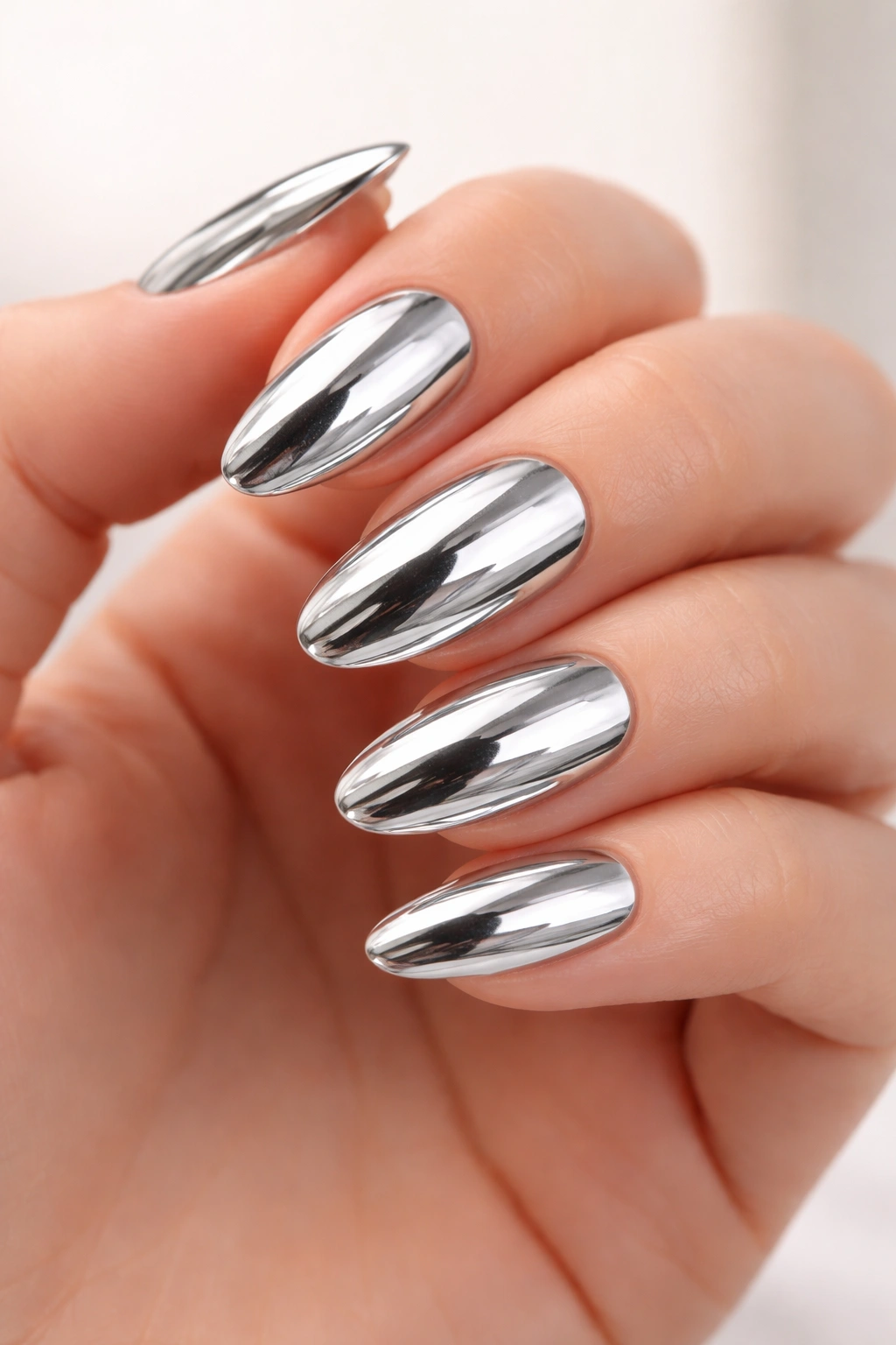 Nails with chrome metallic finish reflecting light