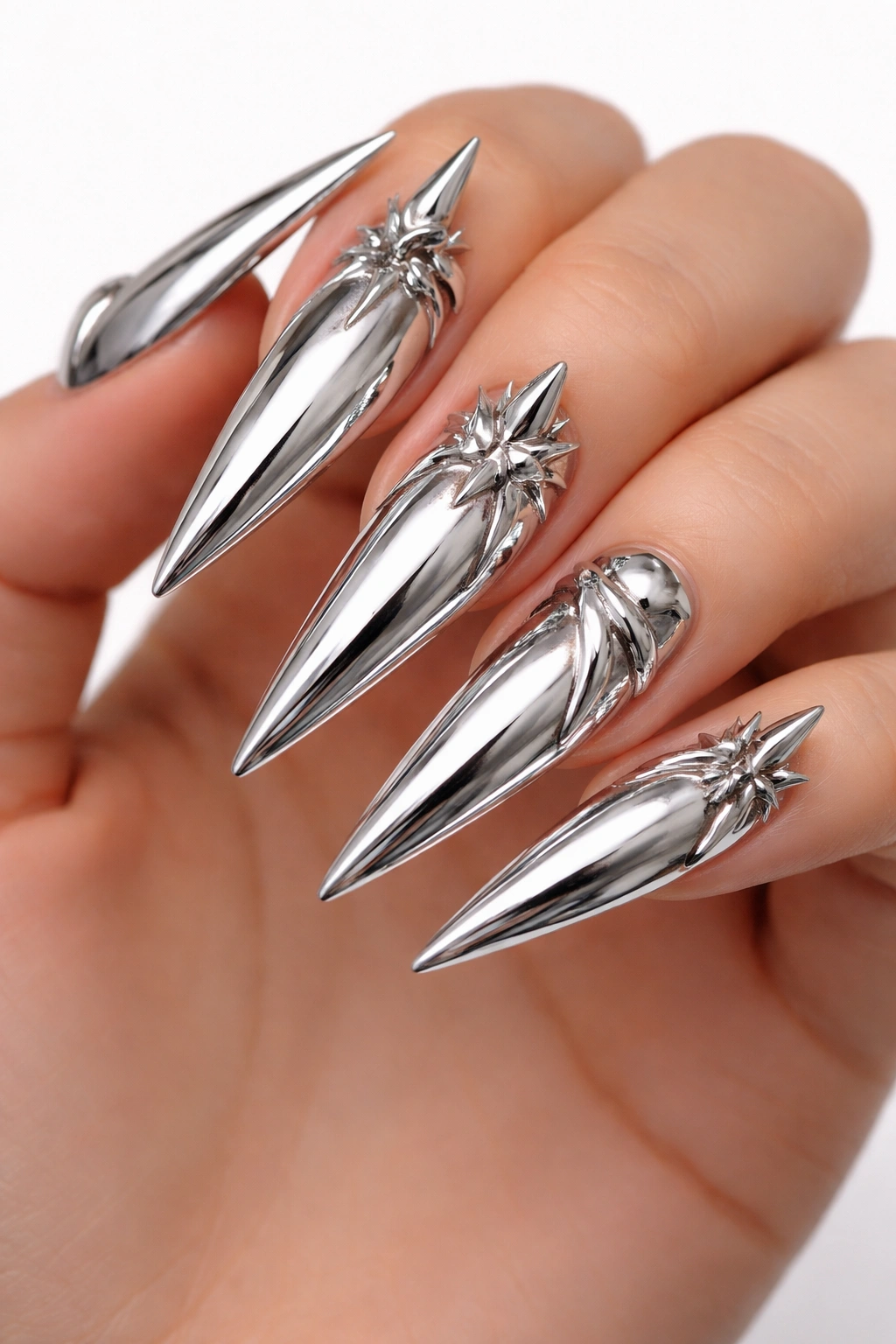 Chrome stiletto nails with 3D chrome elements.