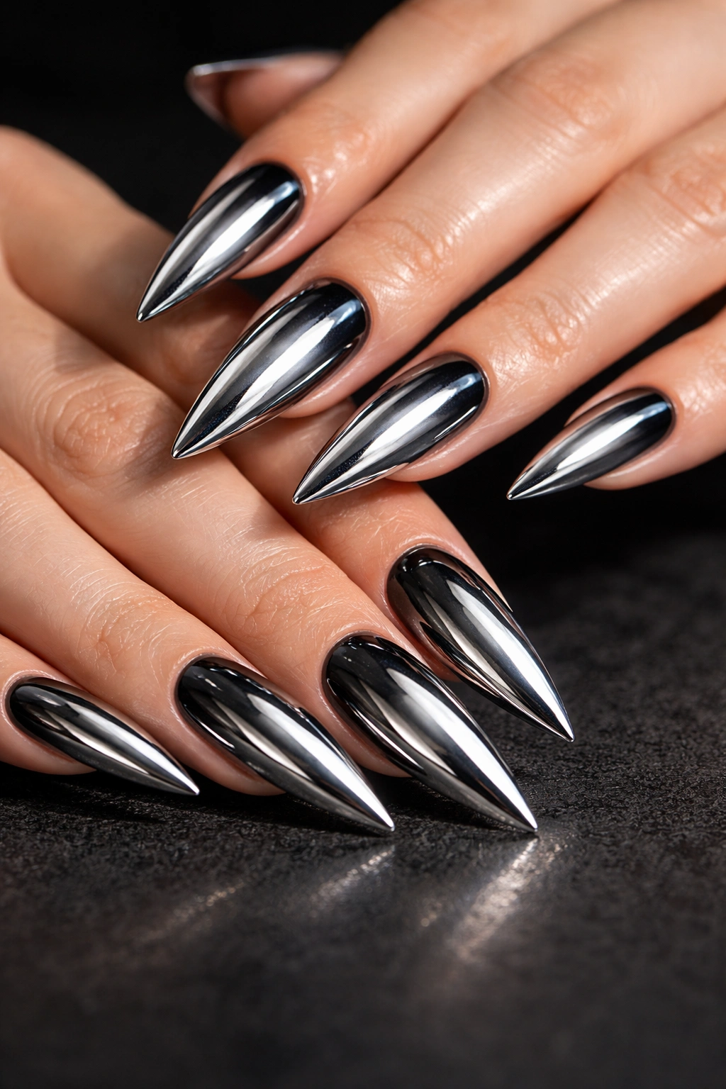 Chrome silver stiletto nails with a dark underlayer