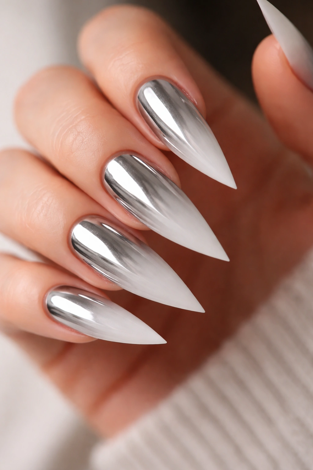 Close-up of chrome ombre stiletto nails with matte tips
