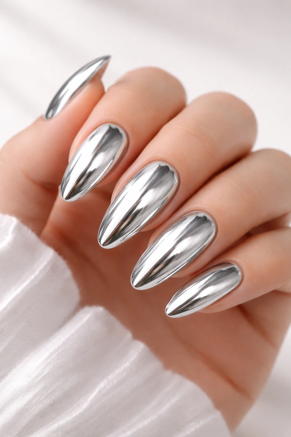 Close-up of chrome silver nails with mirror finish