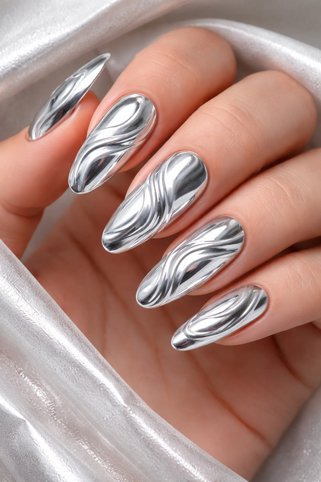 Nails with chrome swirl pattern reflecting light