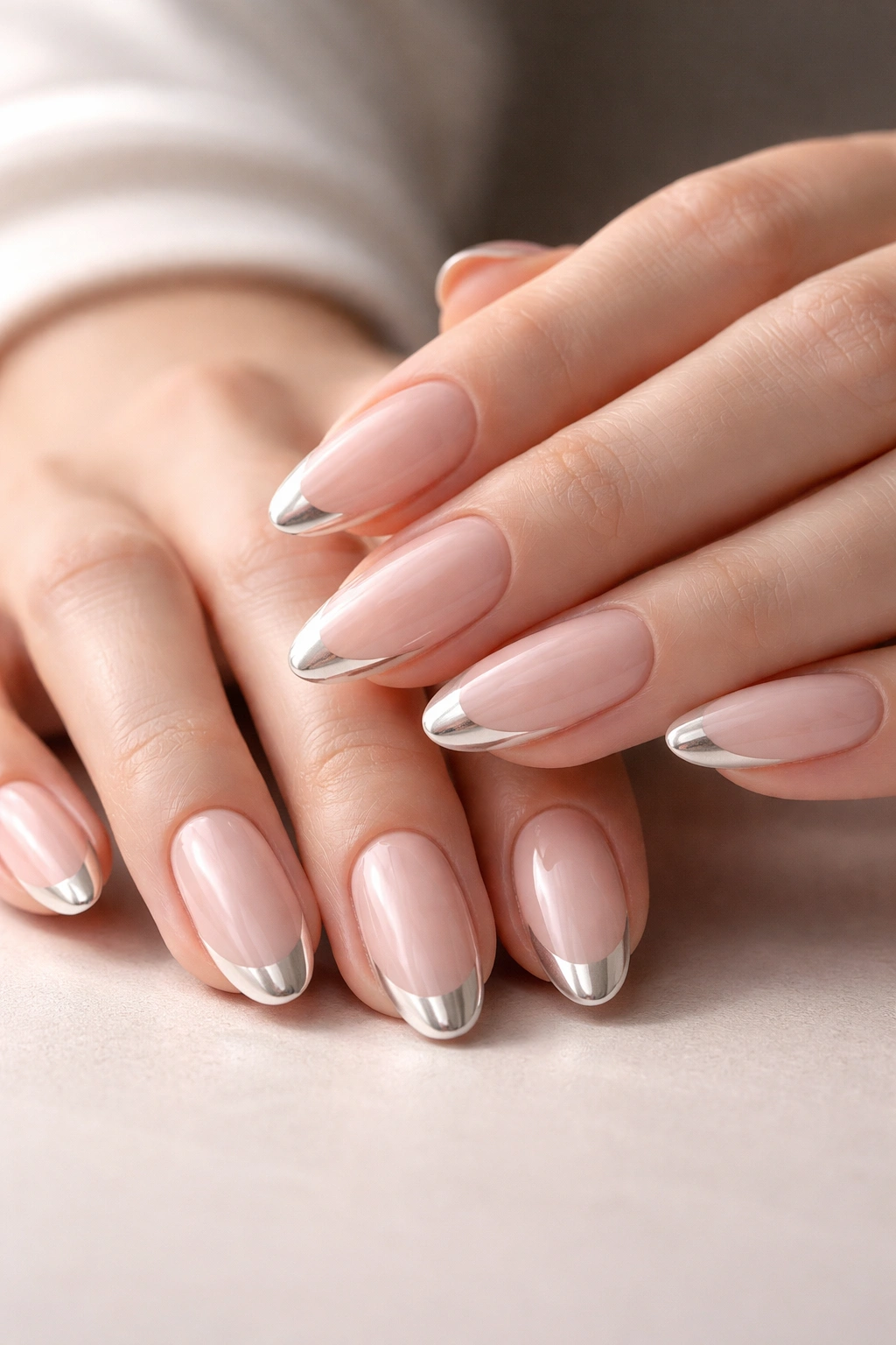 Close-up of hands showing clean chrome tips on nails