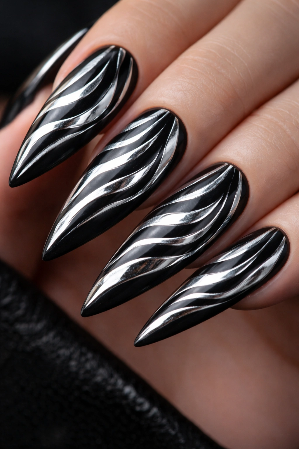 Stiletto nails with chrome zebra stripes over black matte base