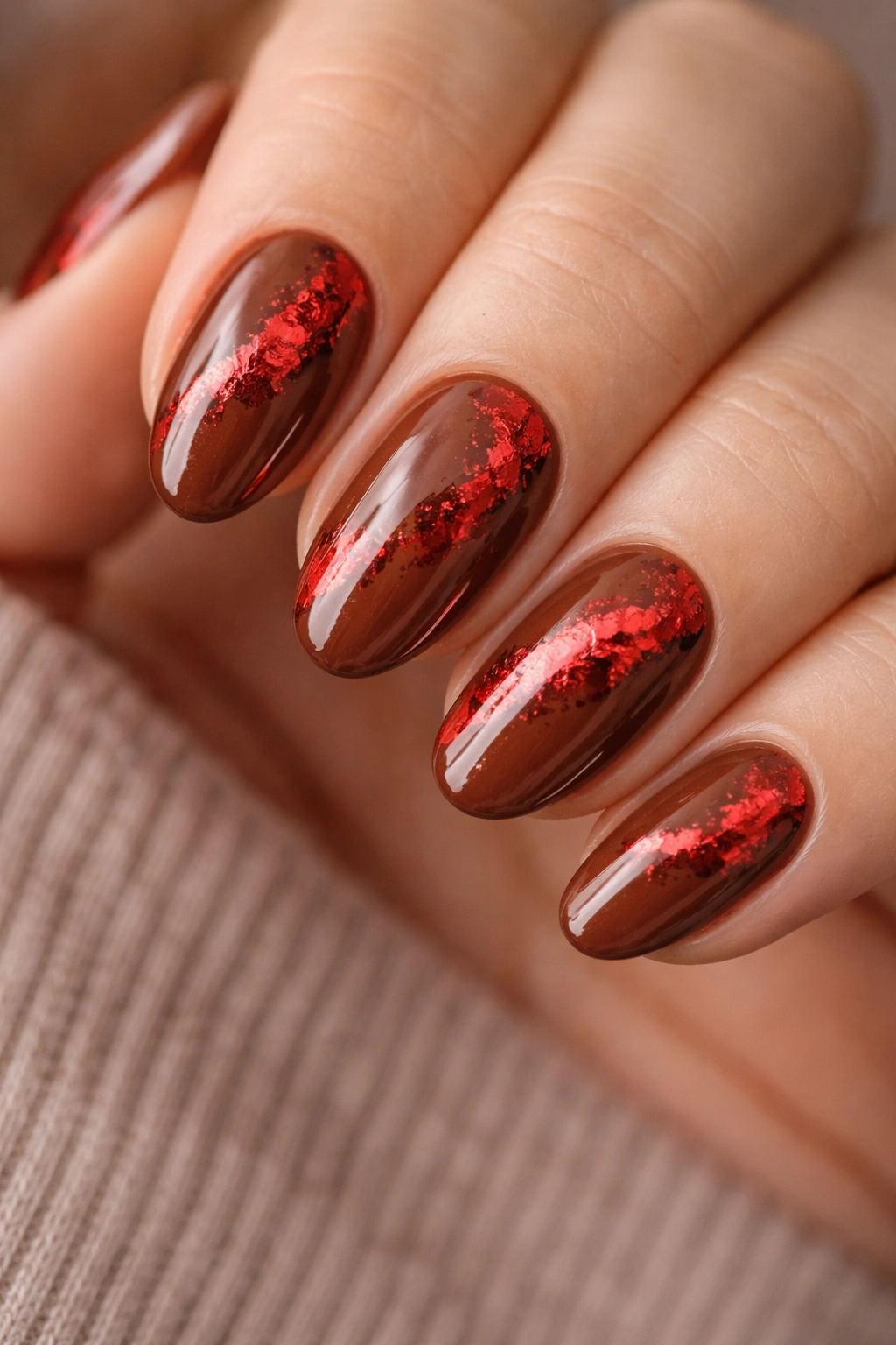 Short almond nails with cinnamon brown base and red foil accents