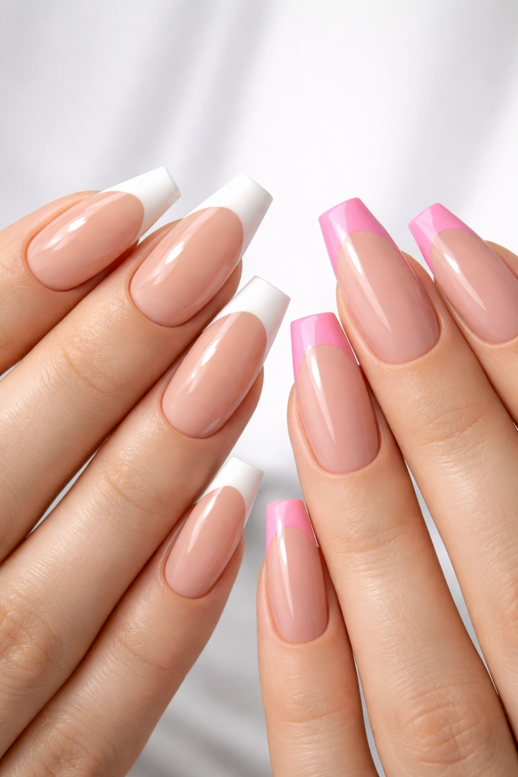 Two hands with updated French tips on coffin nails in coordinated colors