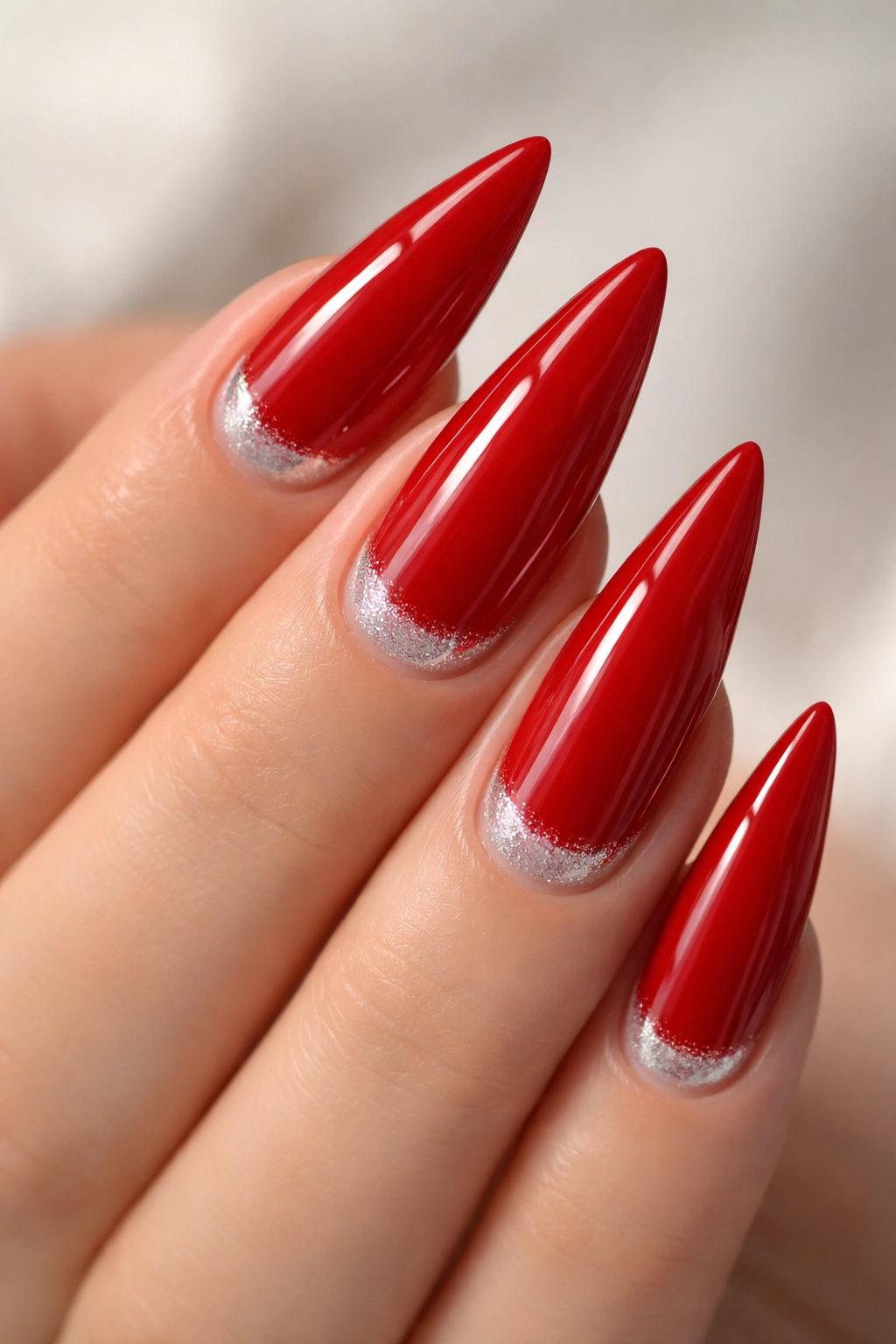 Close-up of classic red nails with cuticle pearl or chrome dust