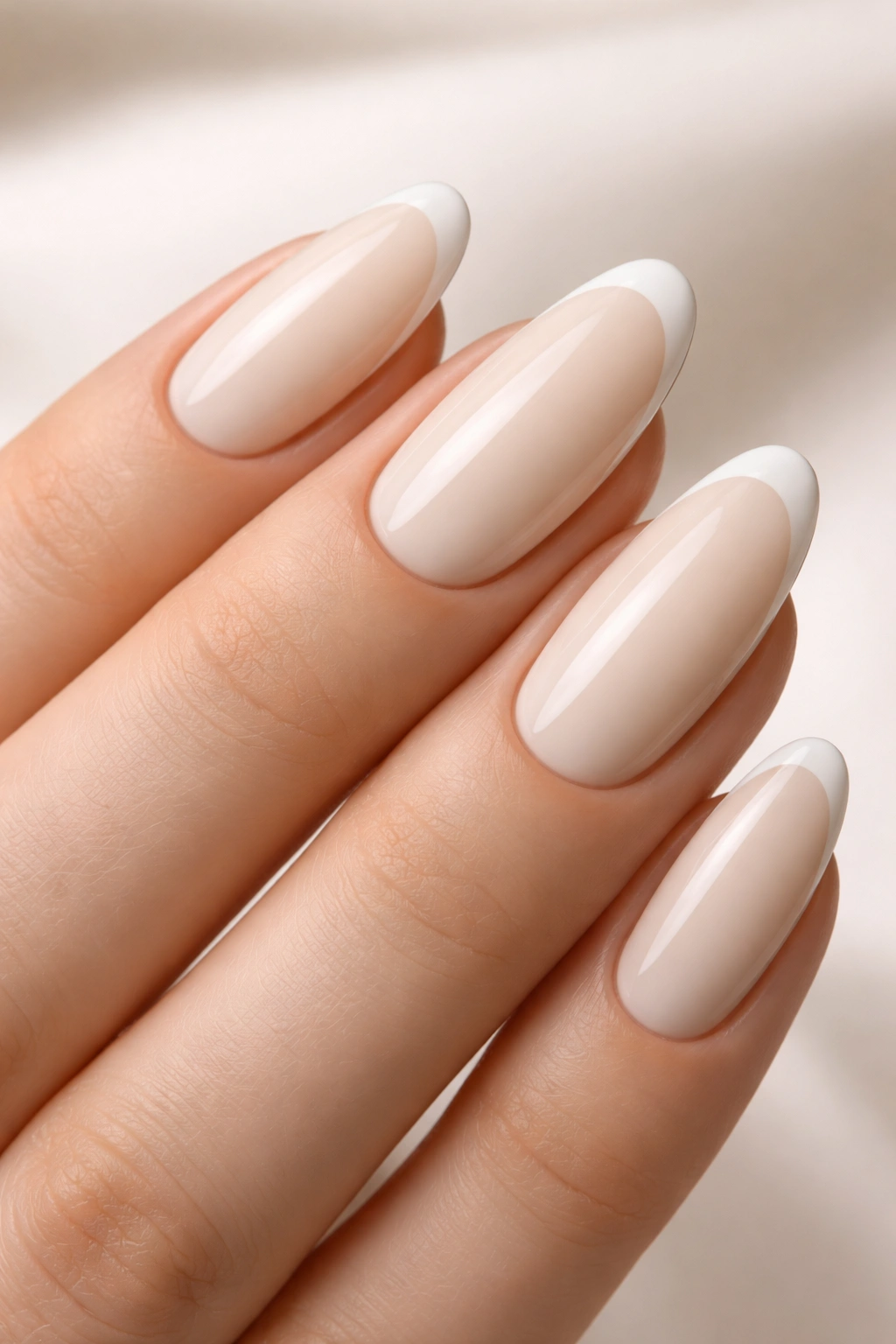 Oval nails in clean cream with sharp edge lines