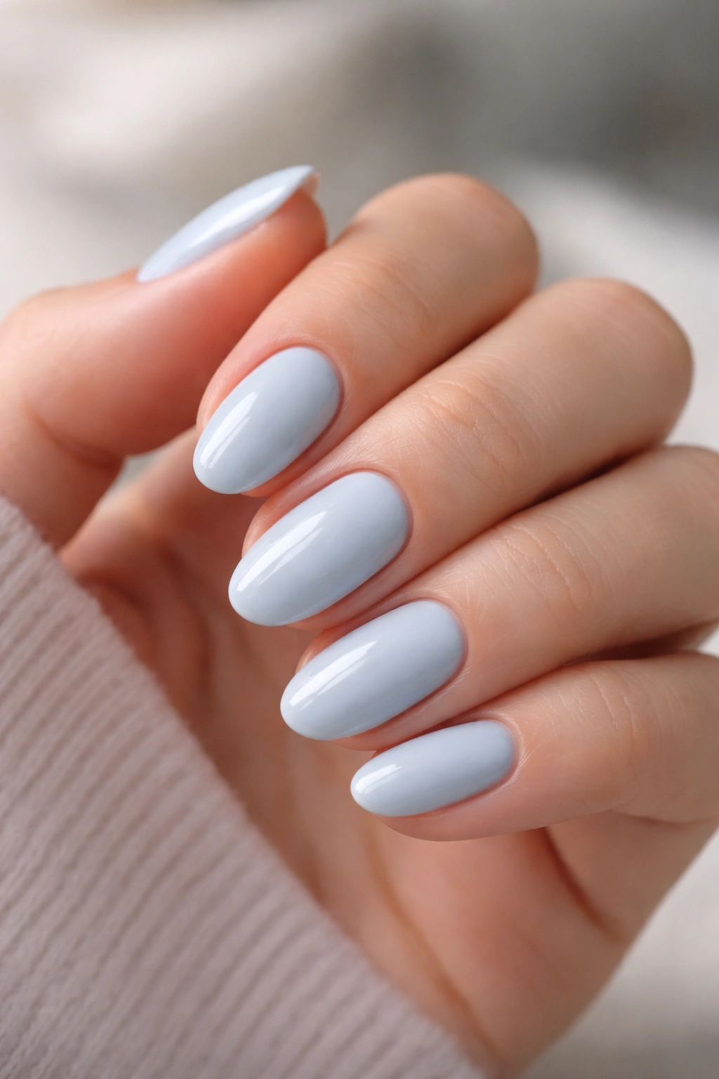 Neatly shaped short almond nails with clean cuticles and glossy finish