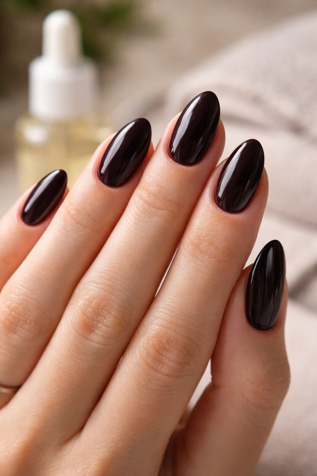 Close-up of clean, glossy short almond nails and tidy cuticles