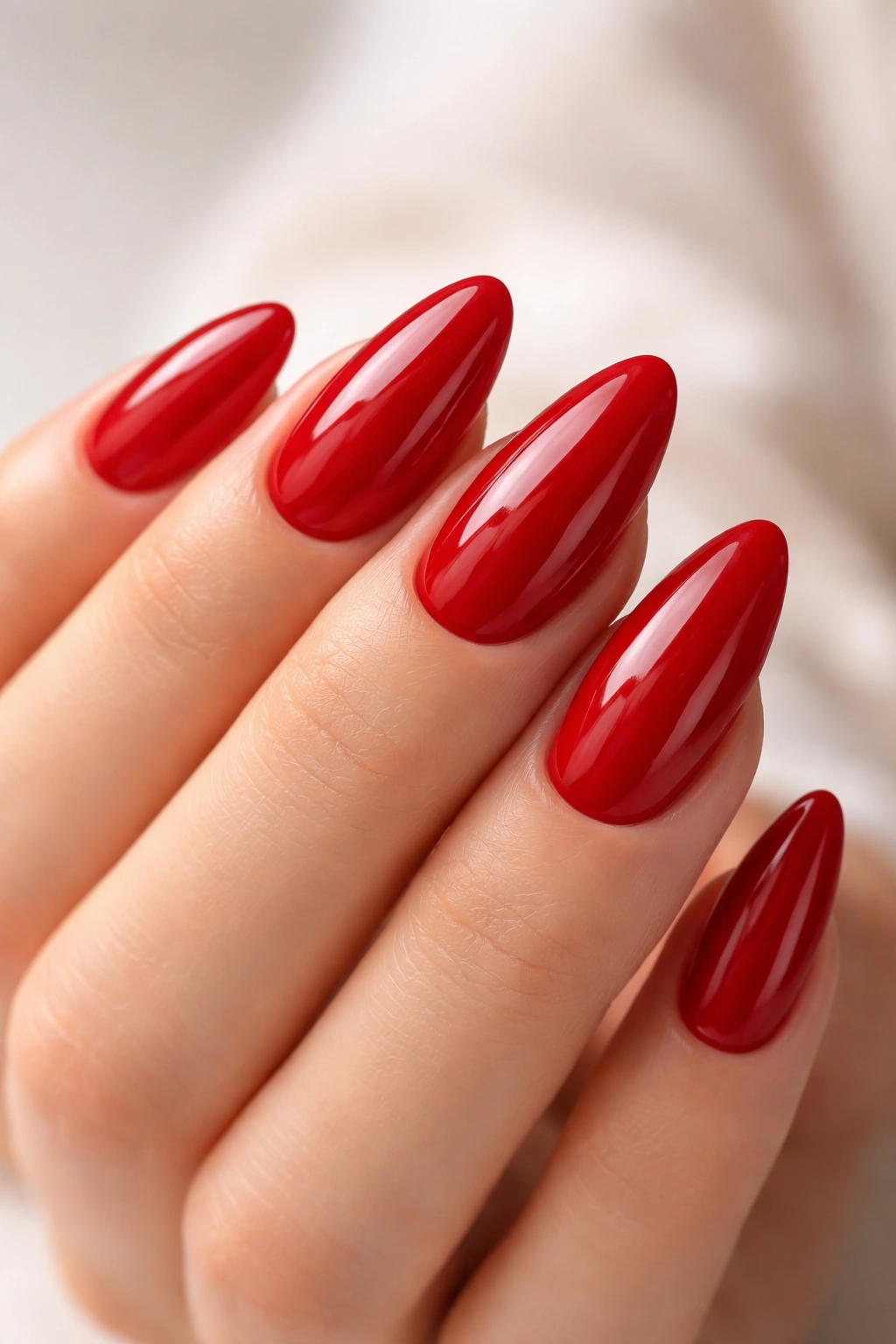 Close-up of clean, glossy red almond nails