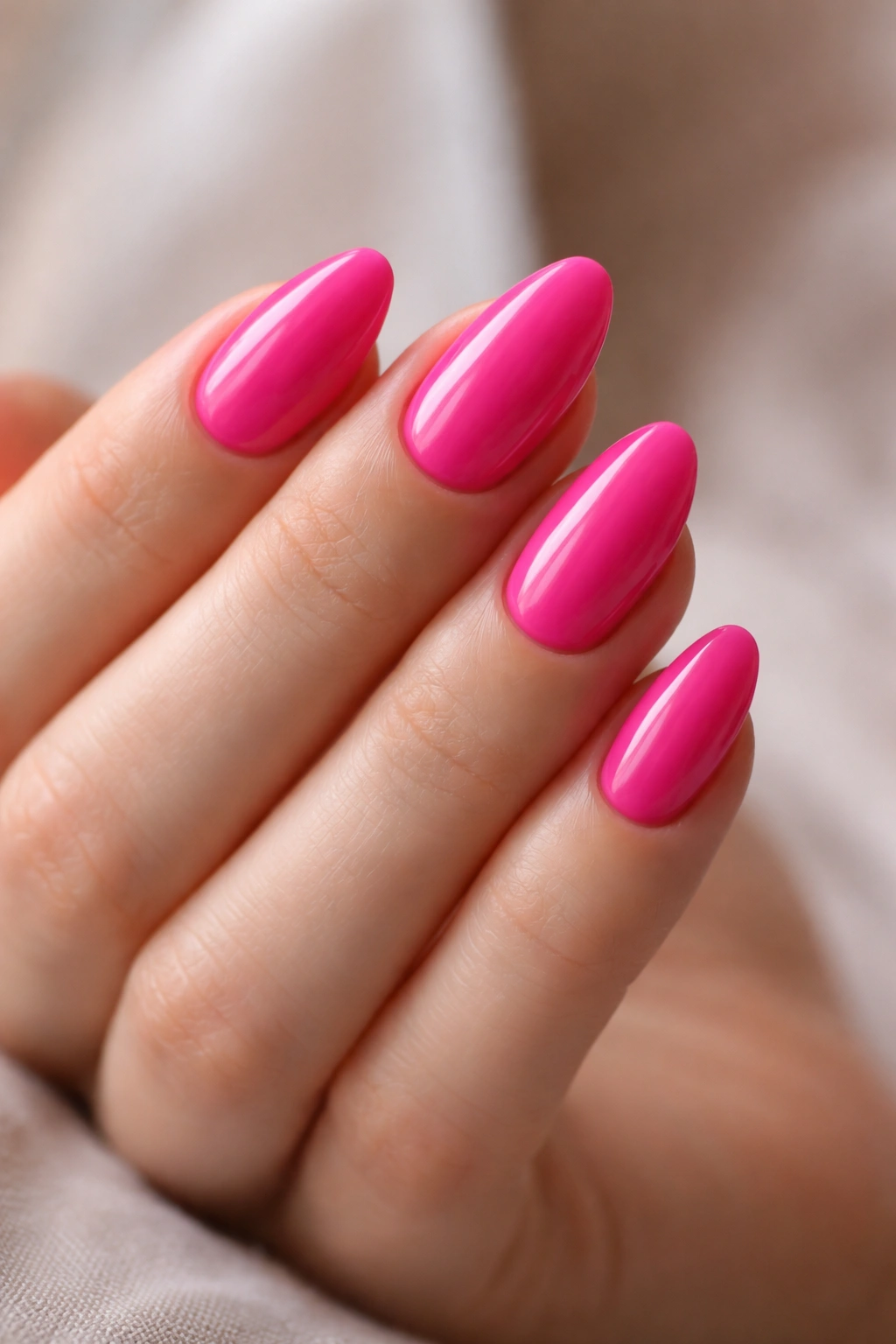 Close-up of clean, short almond nails with smooth cuticles and shine