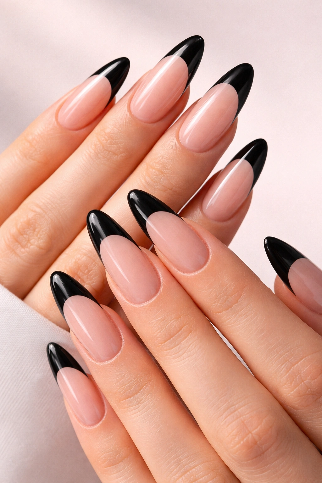Clear oval nails with precise black tips on long nails