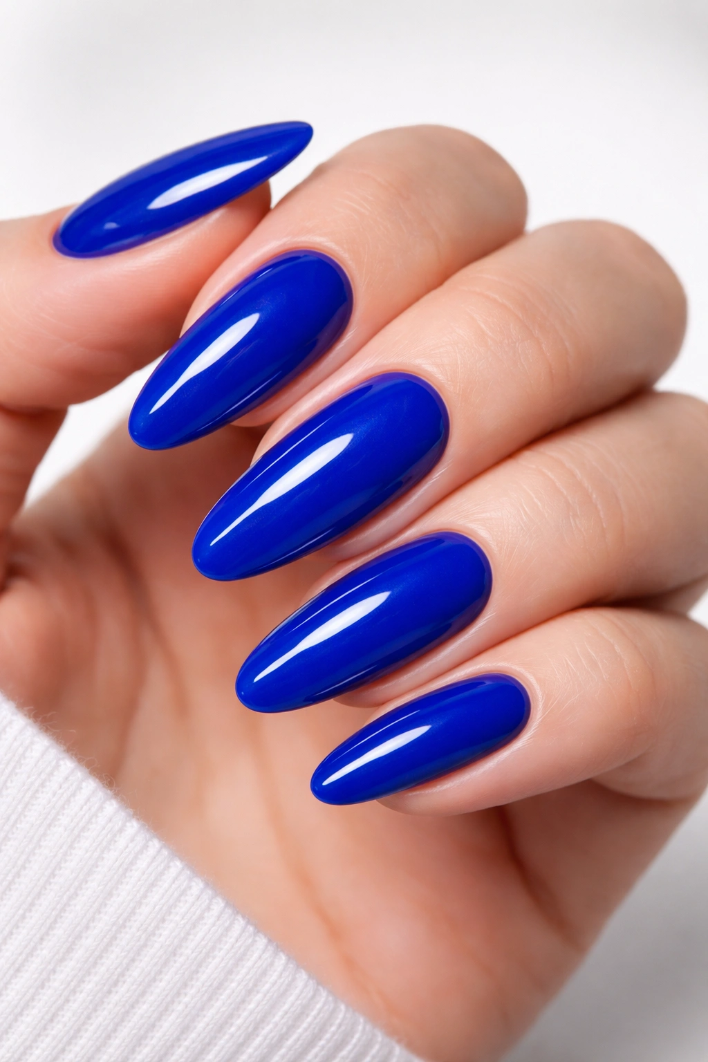 Close-up of cobalt blue dip powder nails on natural nails