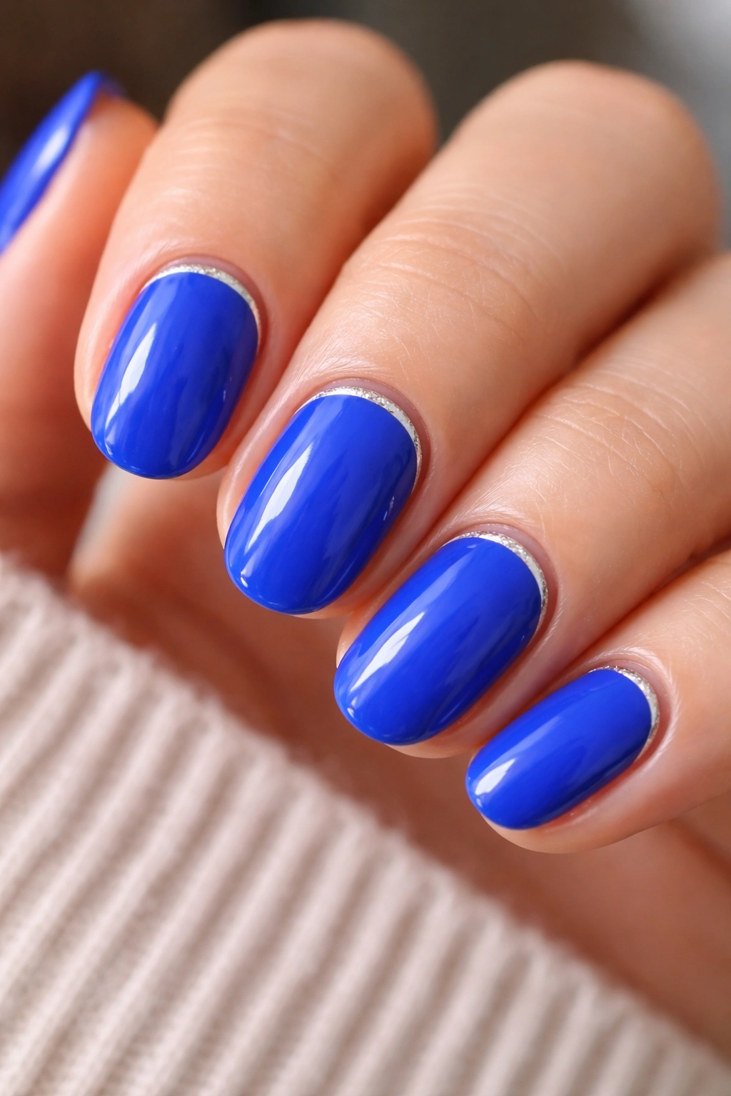 Cobalt blue nails with a silver cuticle line on short ovals