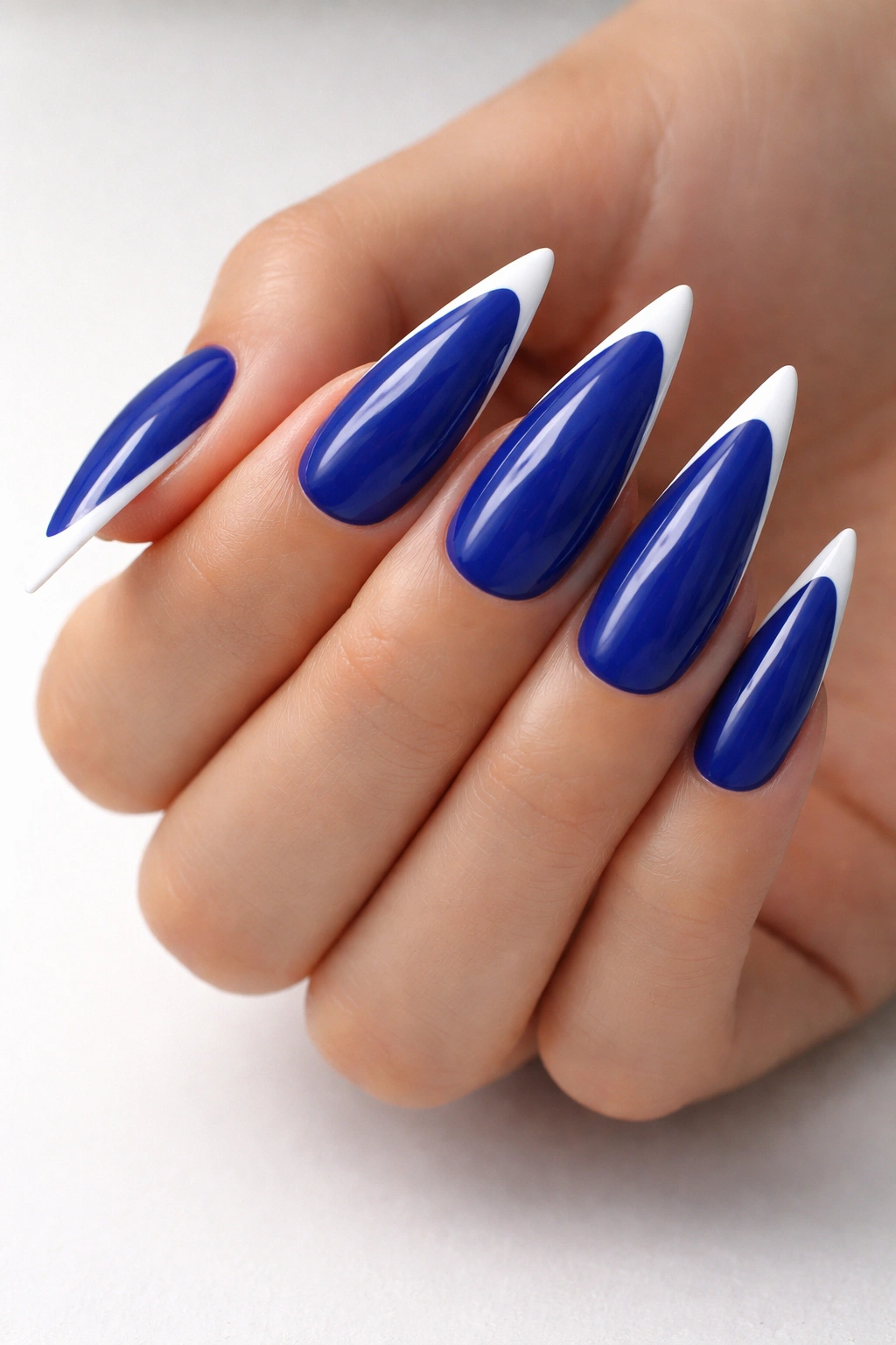 Cobalt blue nails with crisp white tip on stiletto shape