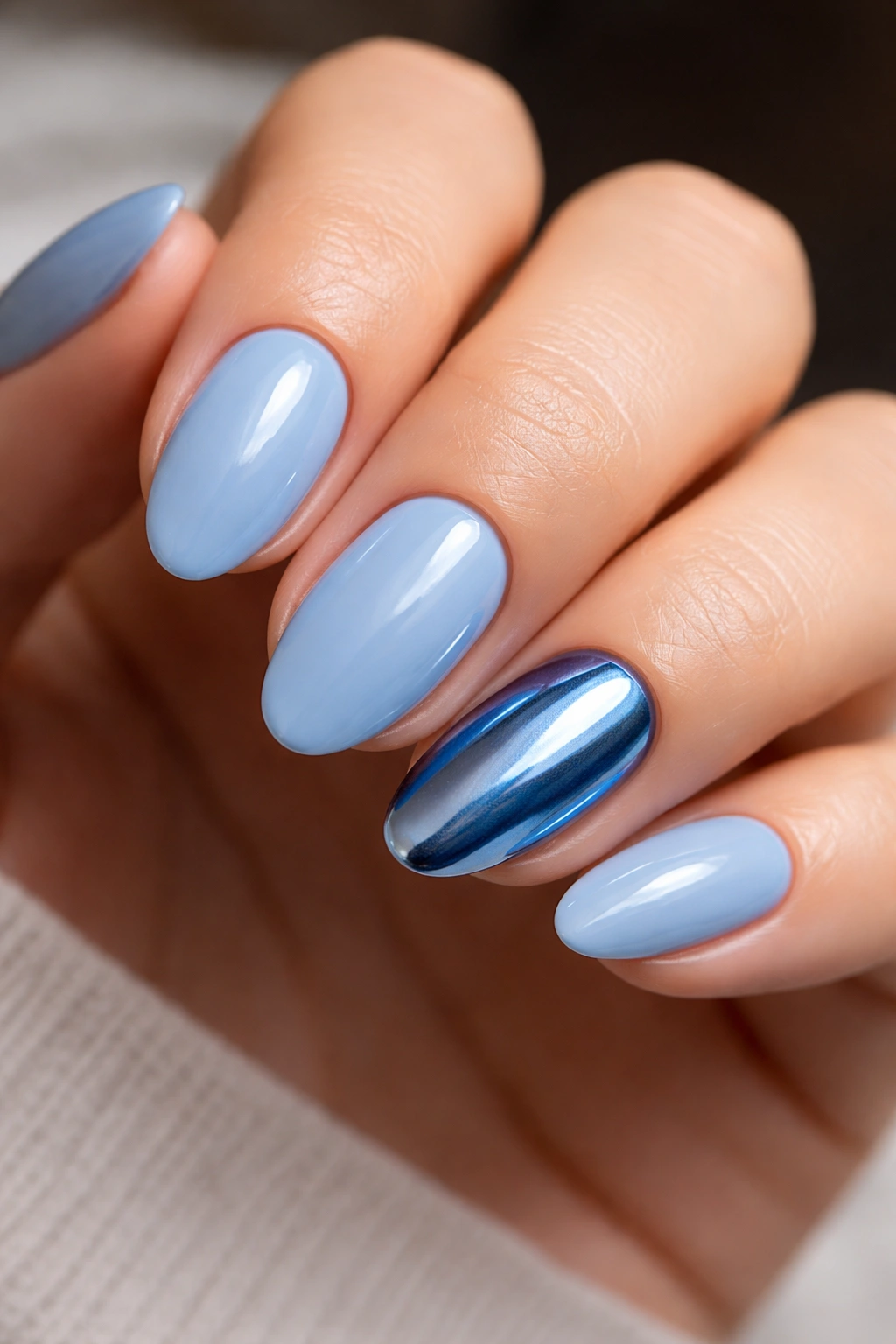 Close-up of short almond nails with cobalt chrome accent nail